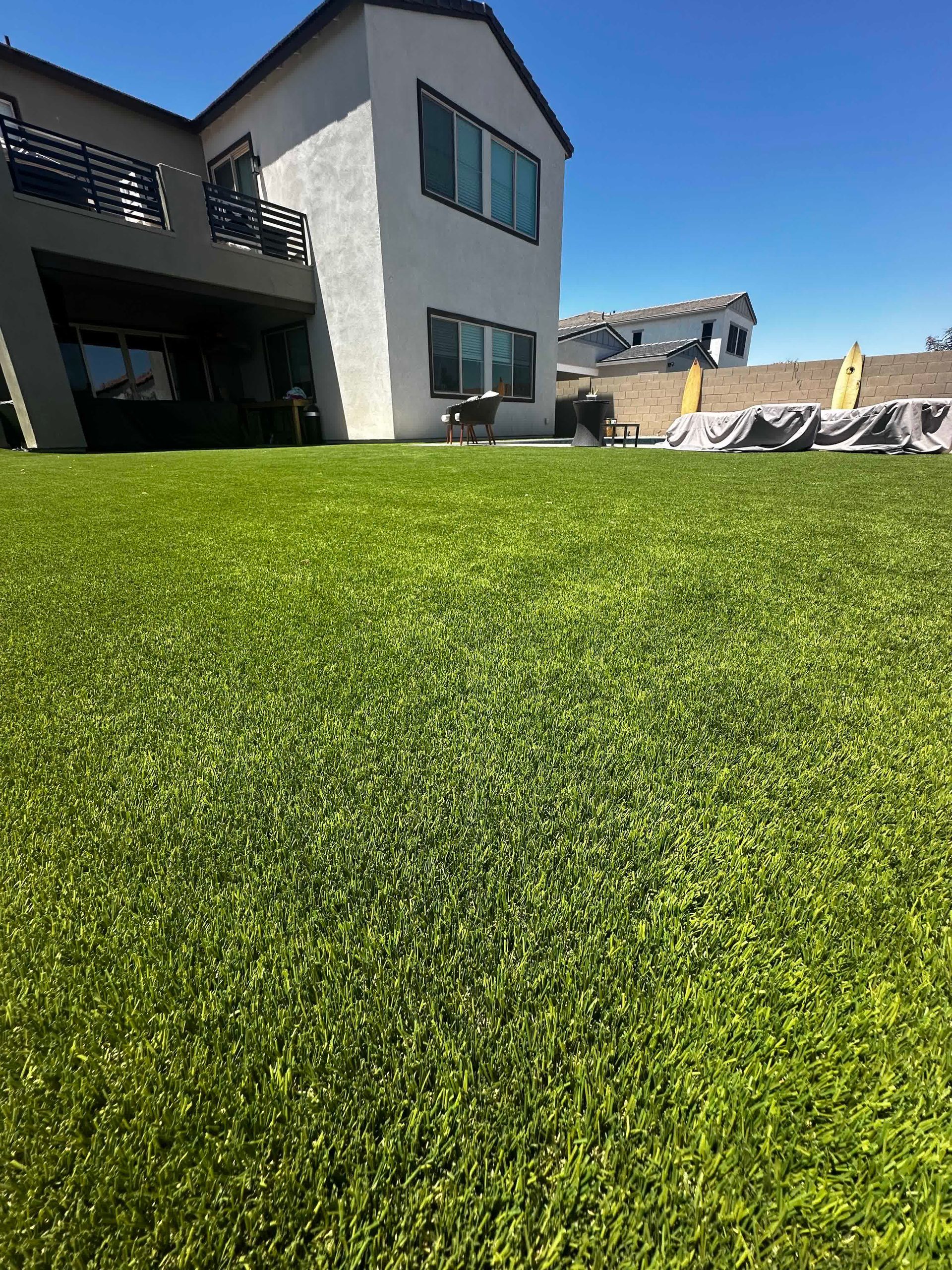 A large house with a lush green lawn in front of it.
