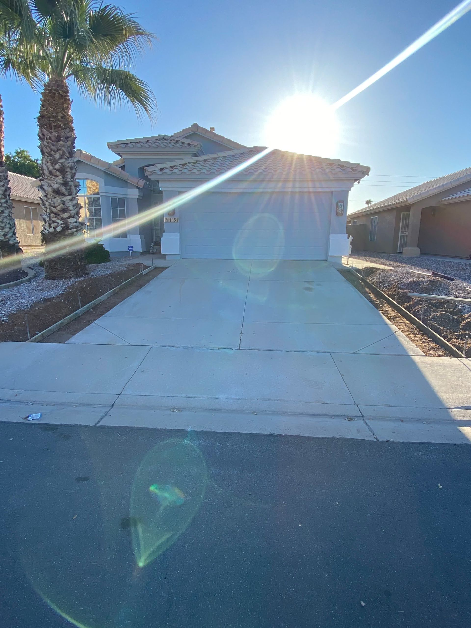 The sun is shining brightly on the front of a house