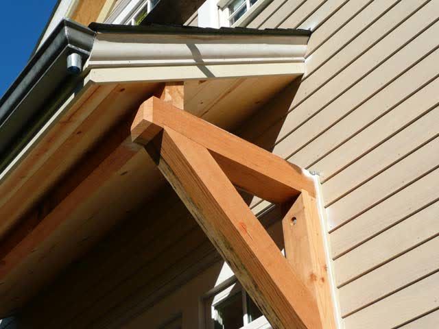 A wooden structure is attached to the side of a house