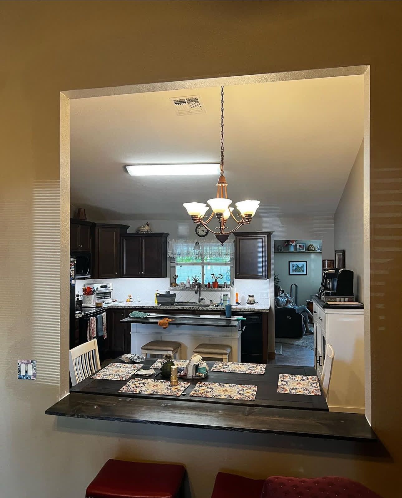 A kitchen with a table and chairs and a chandelier