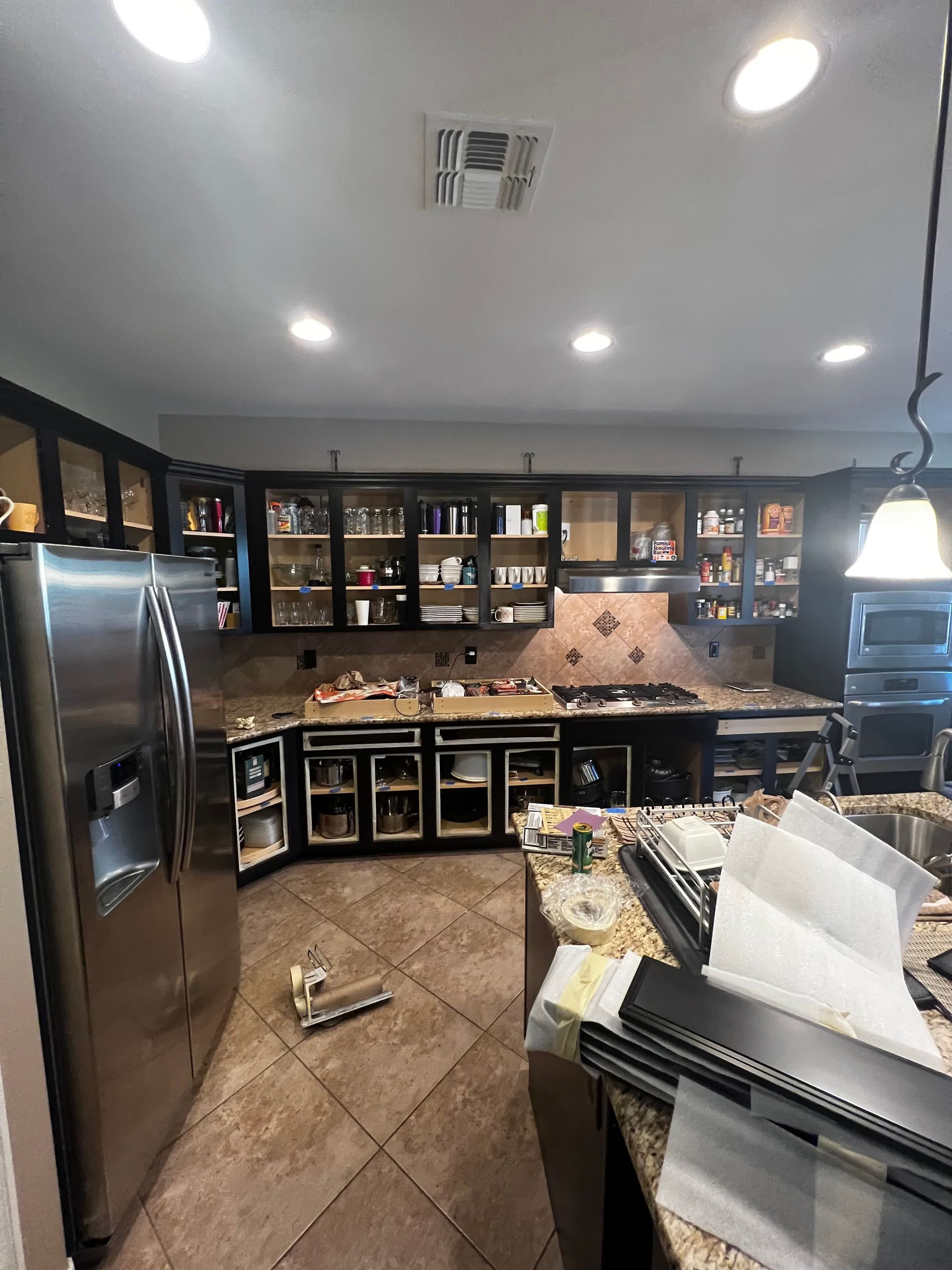 A kitchen with stainless steel appliances and granite counter tops.