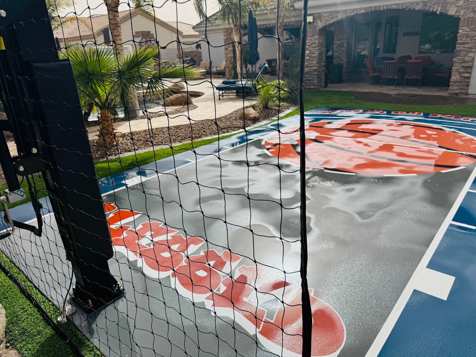 A basketball court with a net and a logo on it