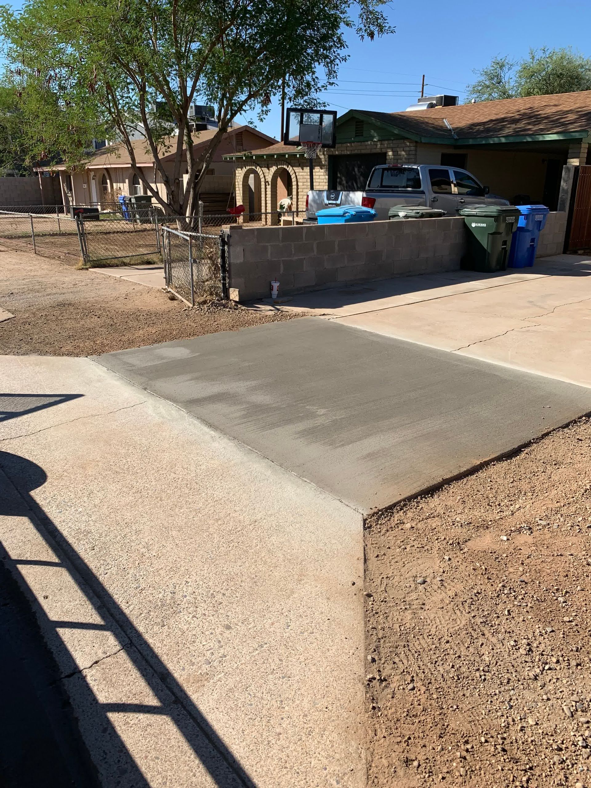 A concrete driveway is being built in front of a house.