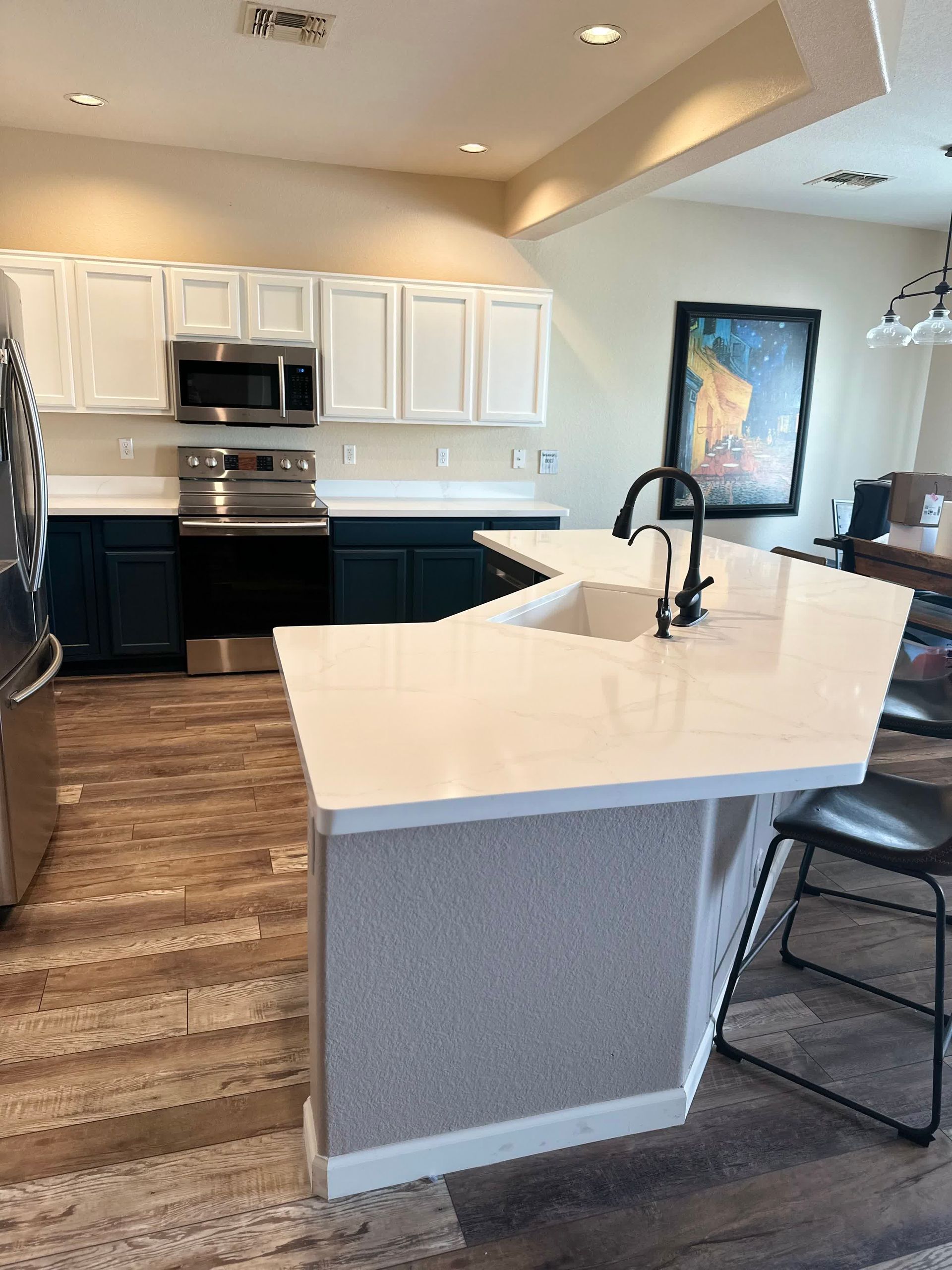 A kitchen with a large island and a sink