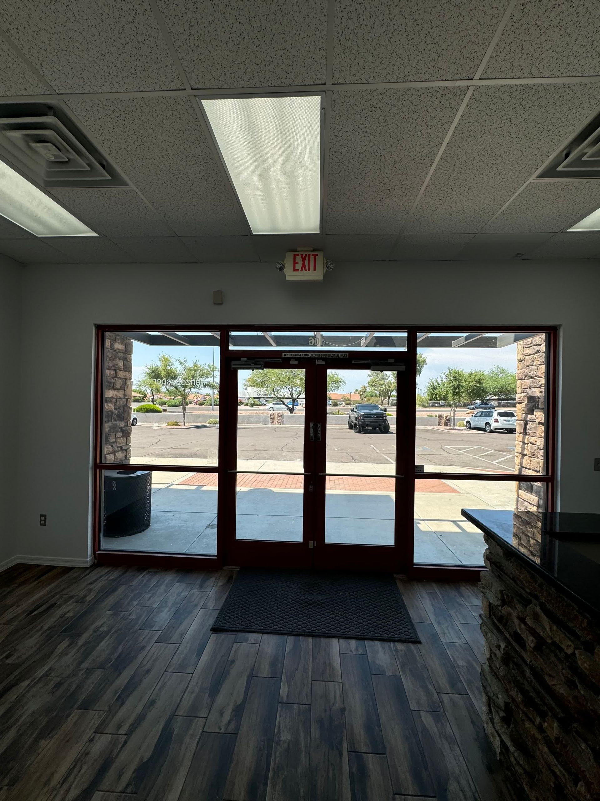 An empty room with a red exit sign on the ceiling