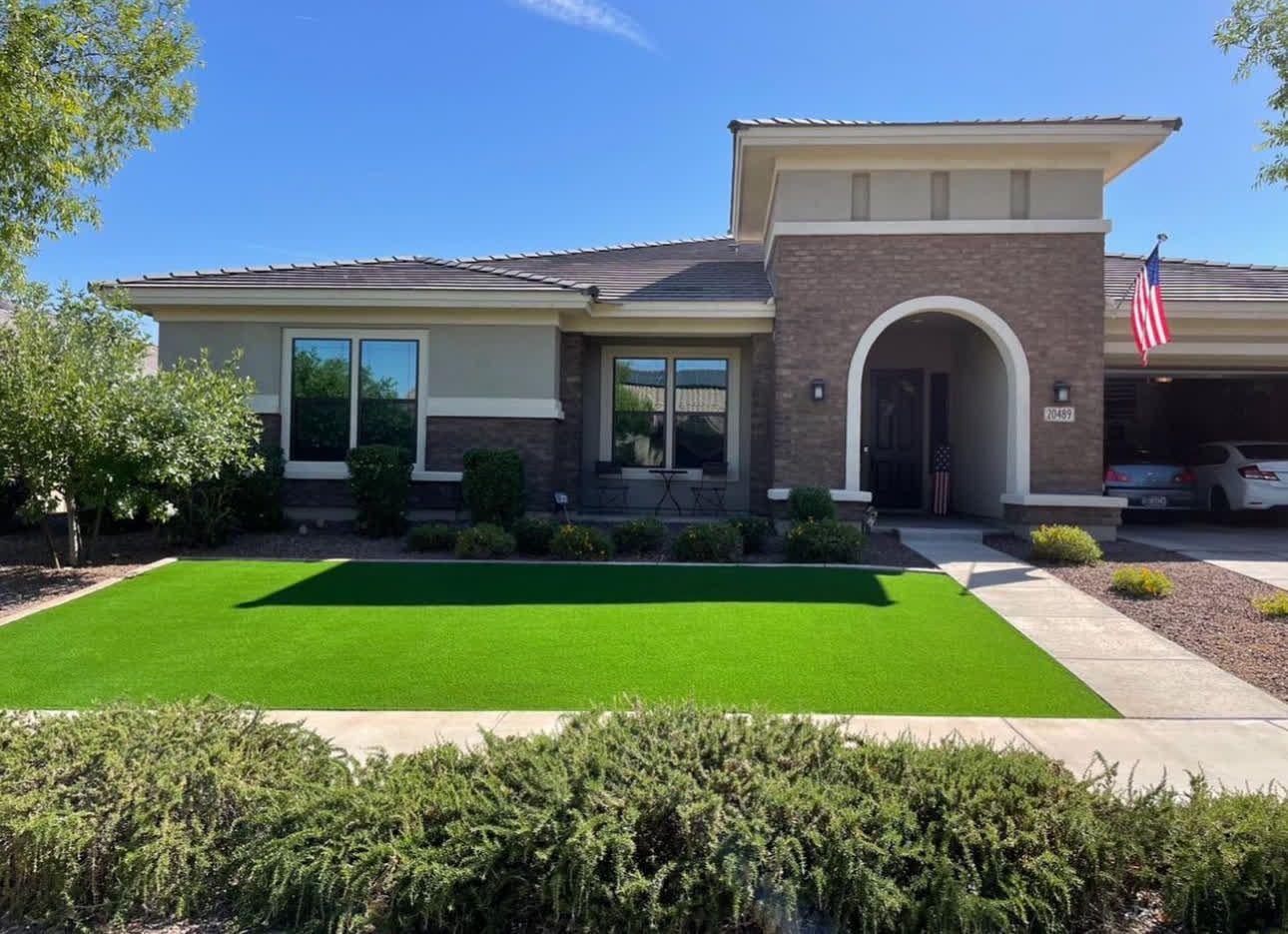 A large house with a lush green lawn in front of it.