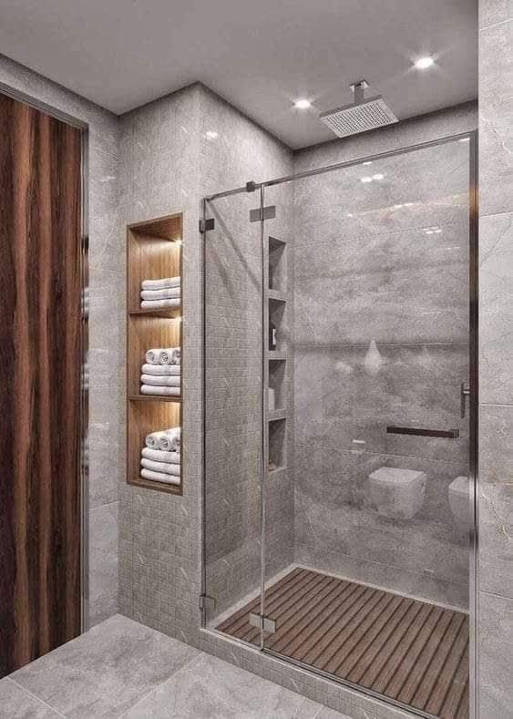 A bathroom with a walk in shower and a wooden floor.
