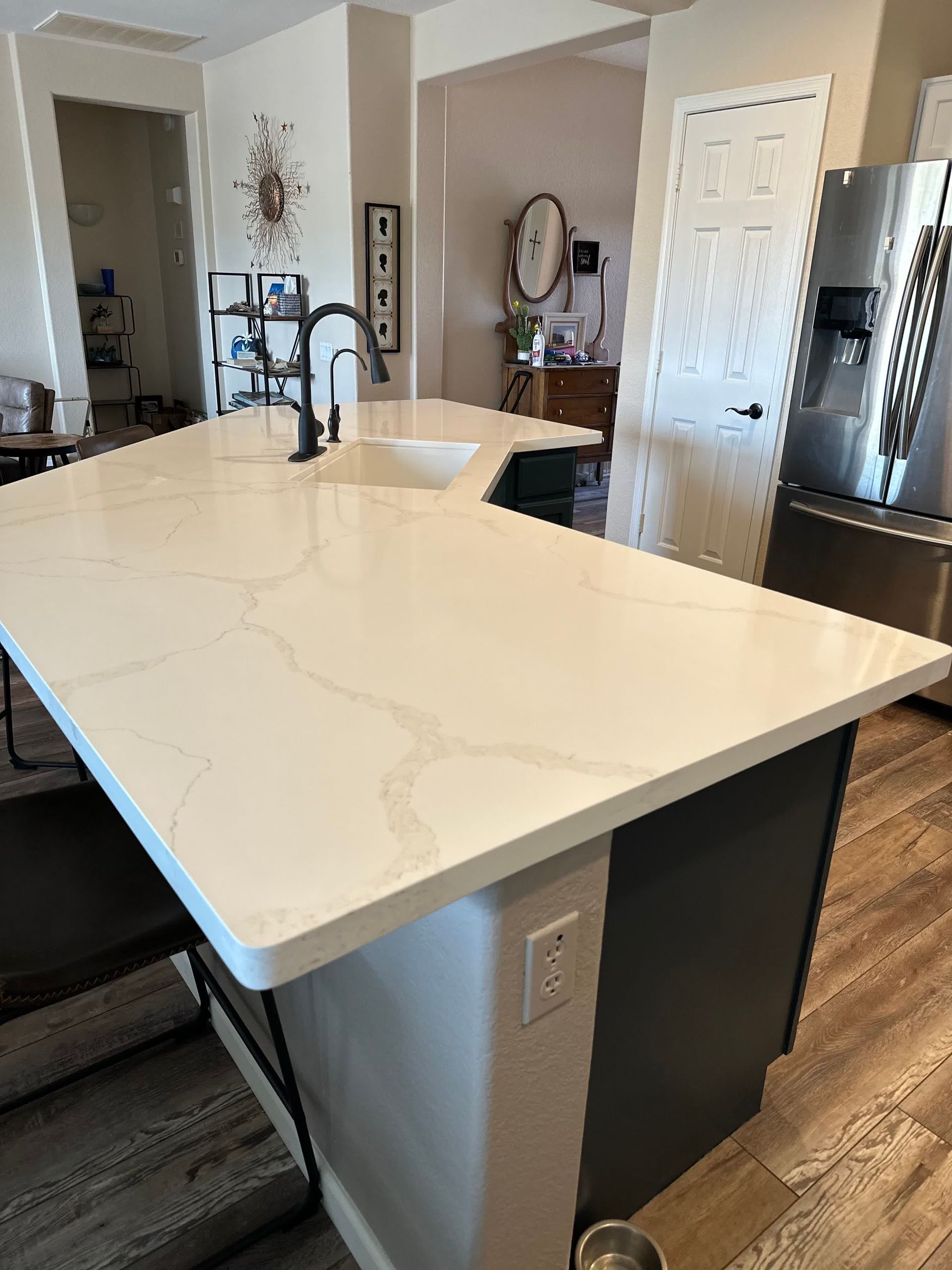 A kitchen with a large island and a sink.