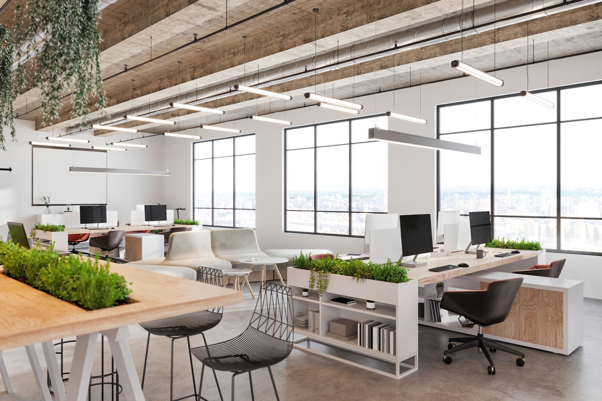 A large open office with lots of windows and tables and chairs.
