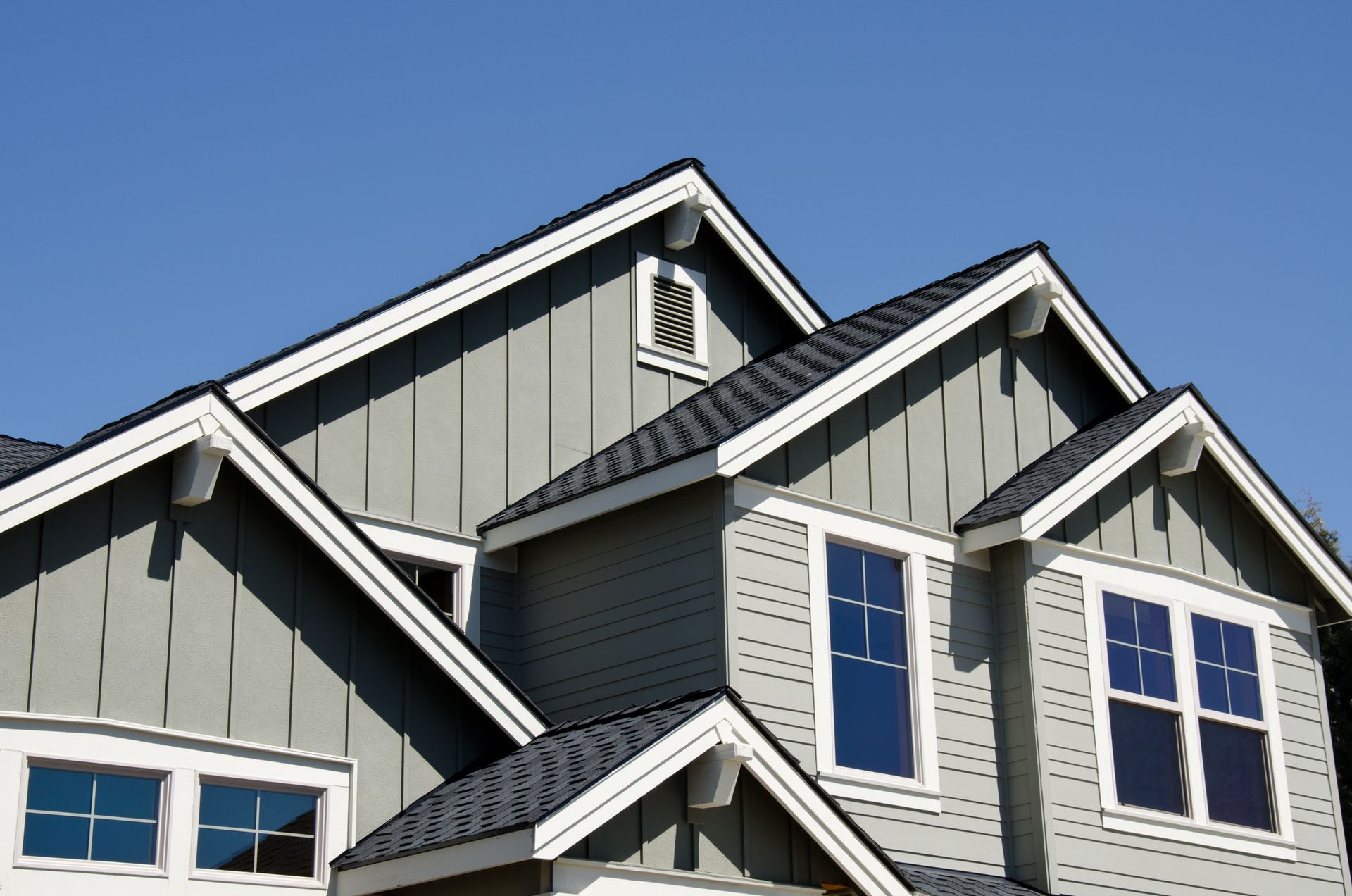 The roof of a house with a blue sky in the background