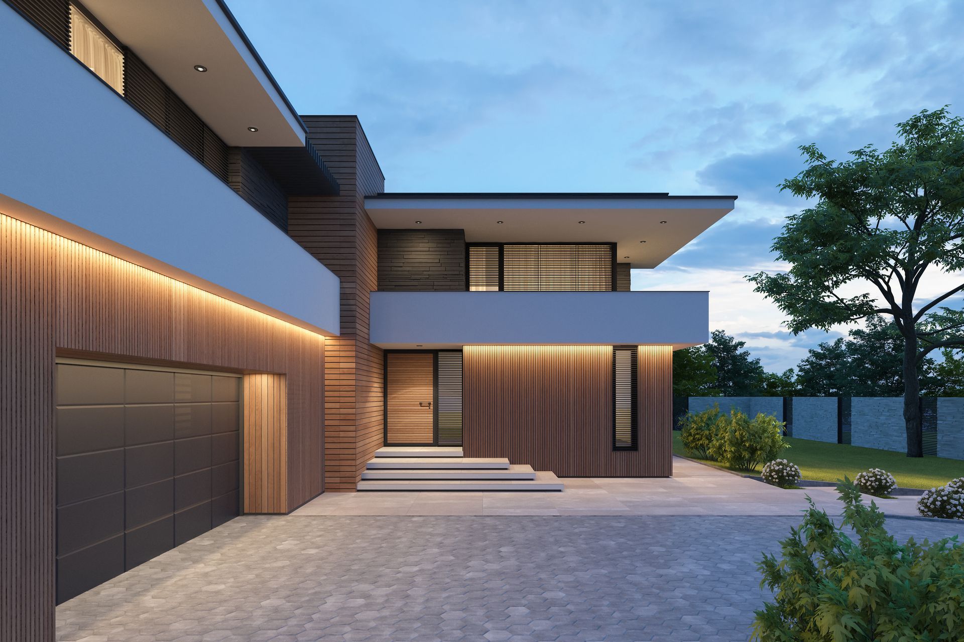 A modern house with a garage and a driveway in front of it.