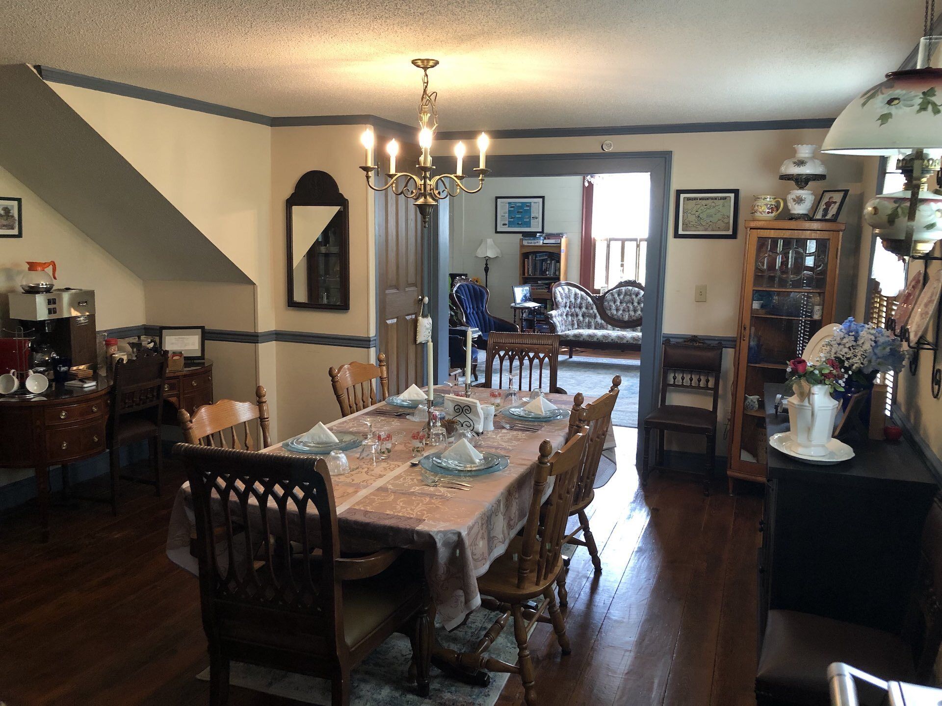 A dining room with a table and chairs and a chandelier