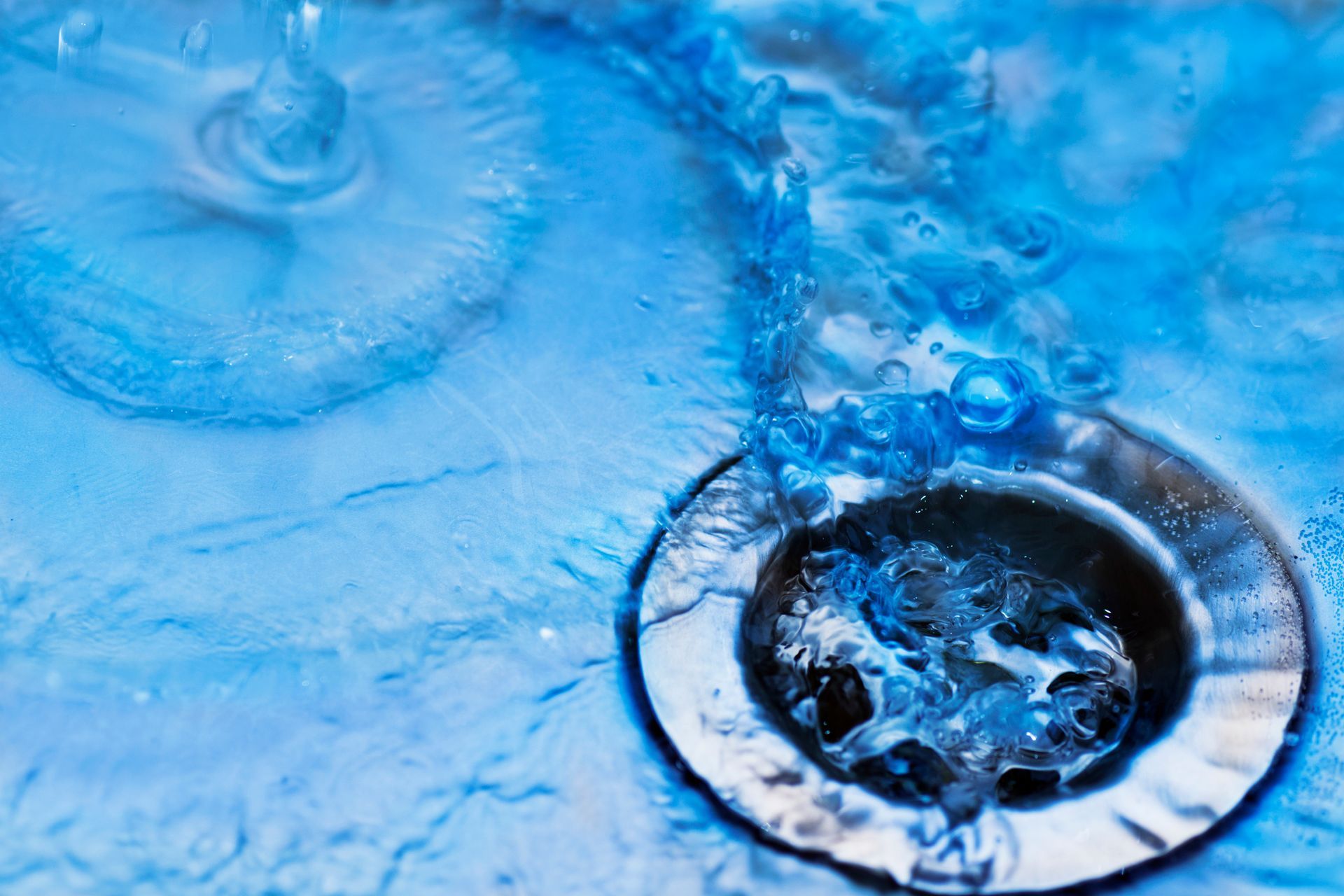 Water draining into a sink. Water draining into a sink.