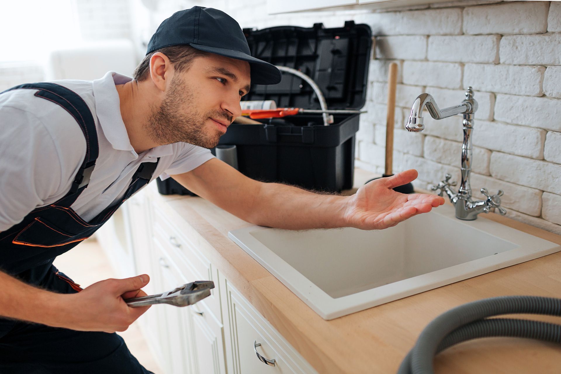 Plumber fixing kitchen sink