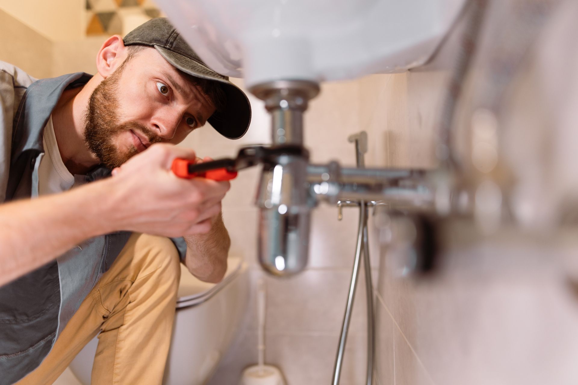 An emergency plumbing contractor providing plumber services to a bathroom sink.