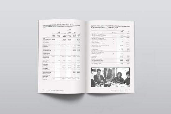 A book is open to a page with a picture of a group of people sitting at a table.
