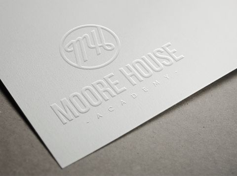 A white piece of paper with the word Moore House embossed on it A design by Agency, Visionar.