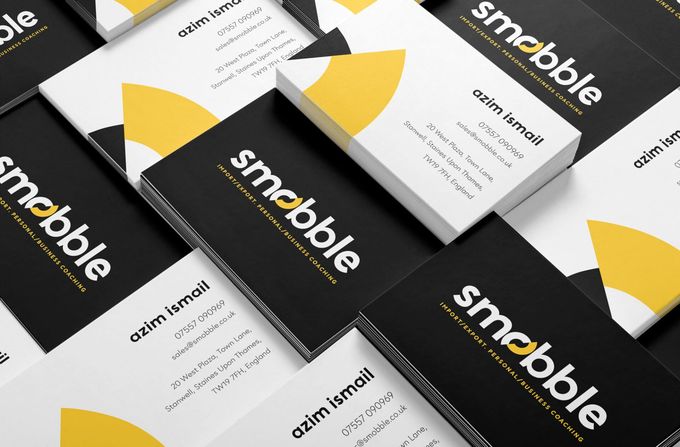 A bunch of business cards are stacked on top of each other.