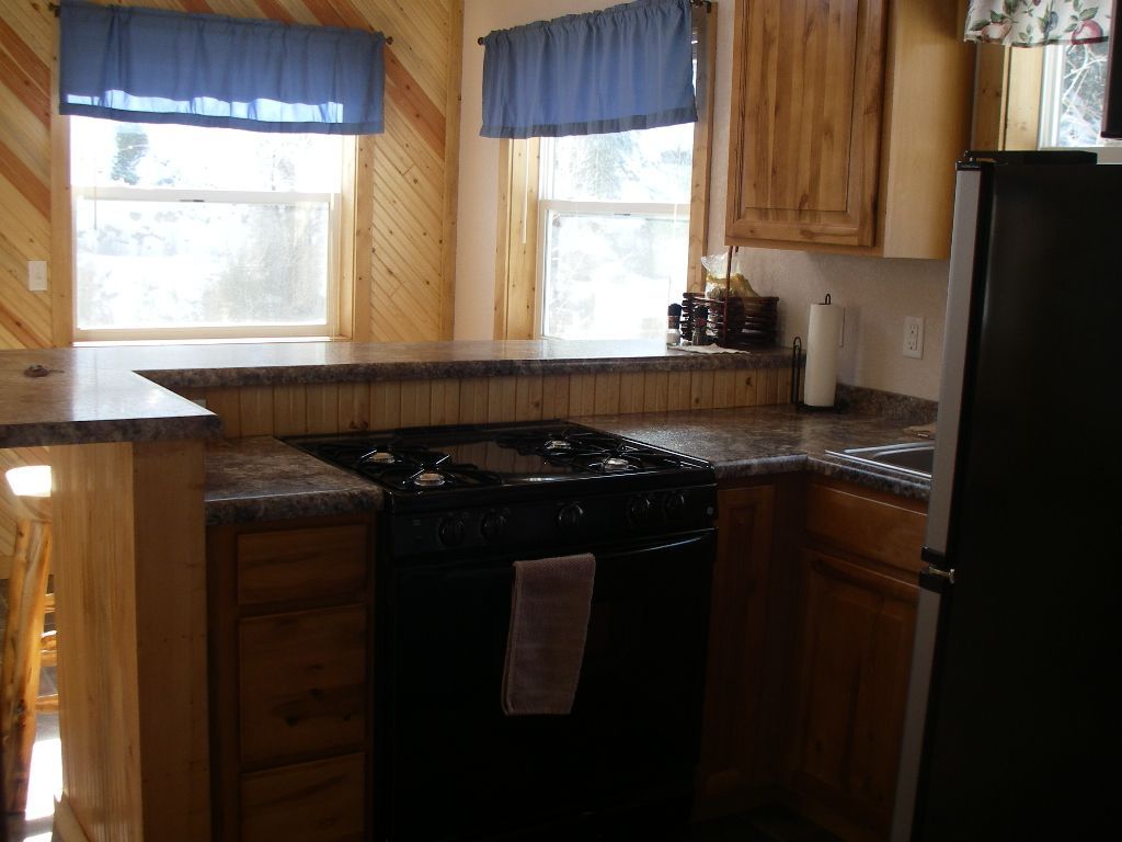 A kitchen with a black stove and a black refrigerator