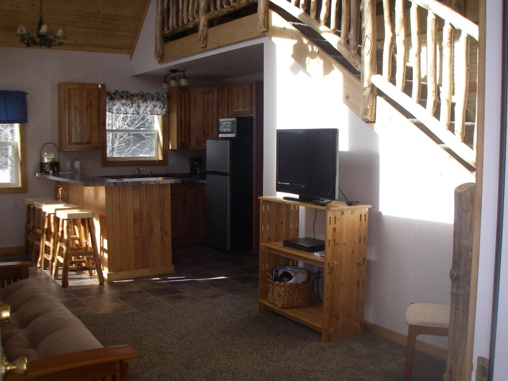 A living room with a couch and a flat screen tv