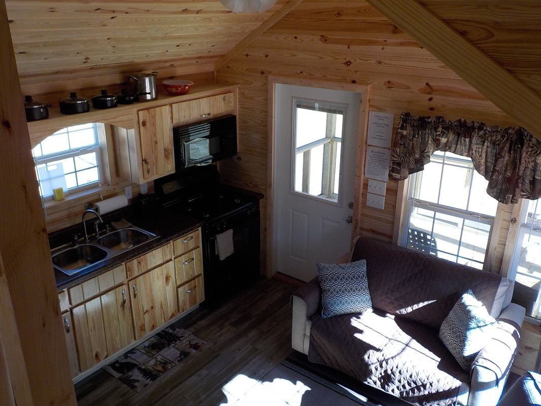 An aerial view of a living room and kitchen in a cabin.
