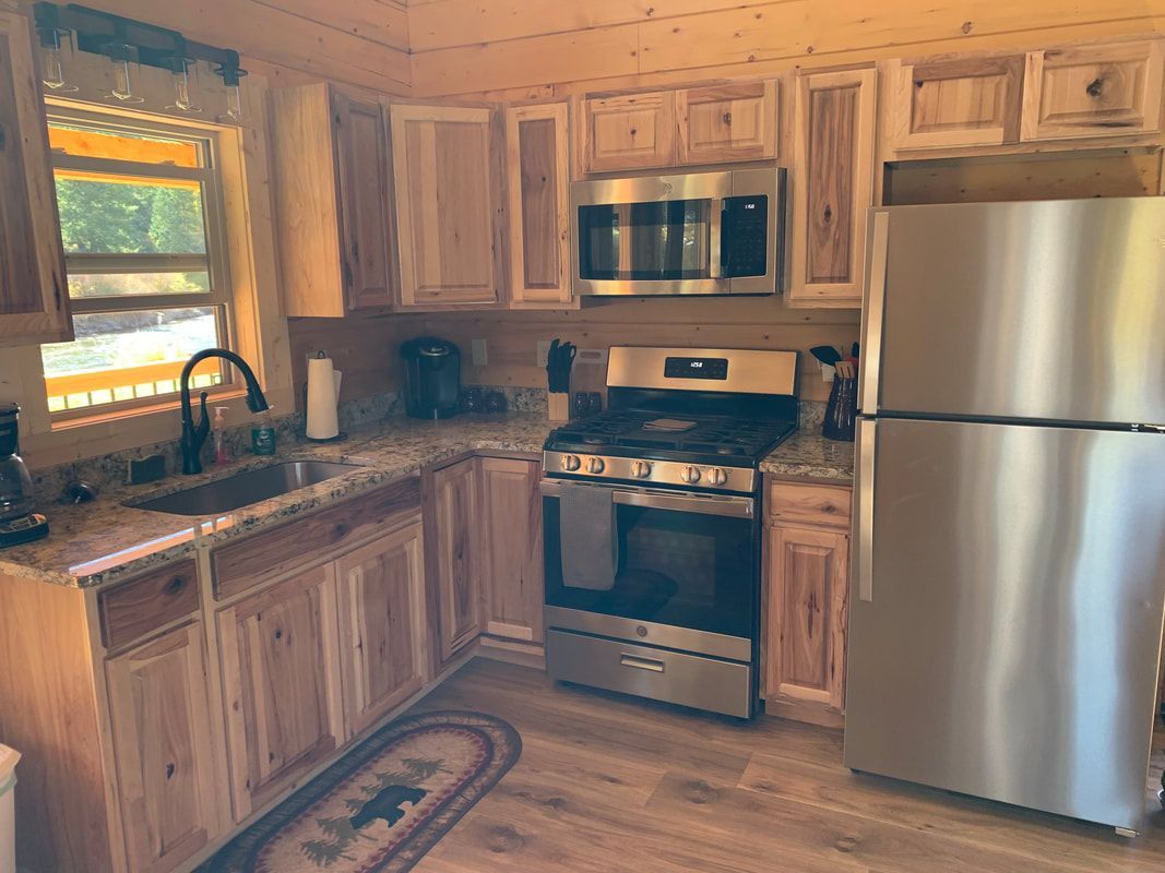 A kitchen with stainless steel appliances and wooden cabinets.