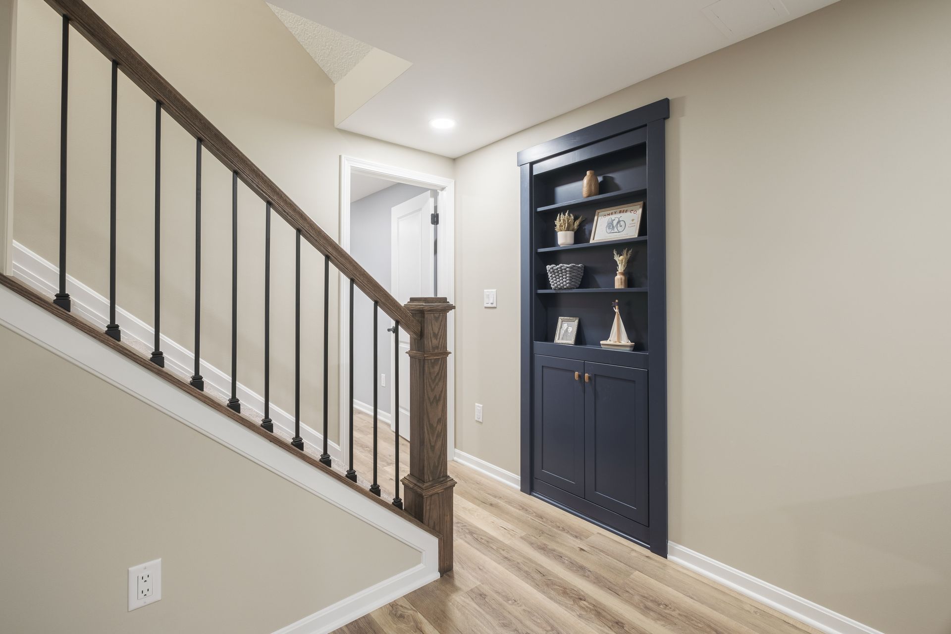 A hallway with stairs leading up to the second floor of a house.