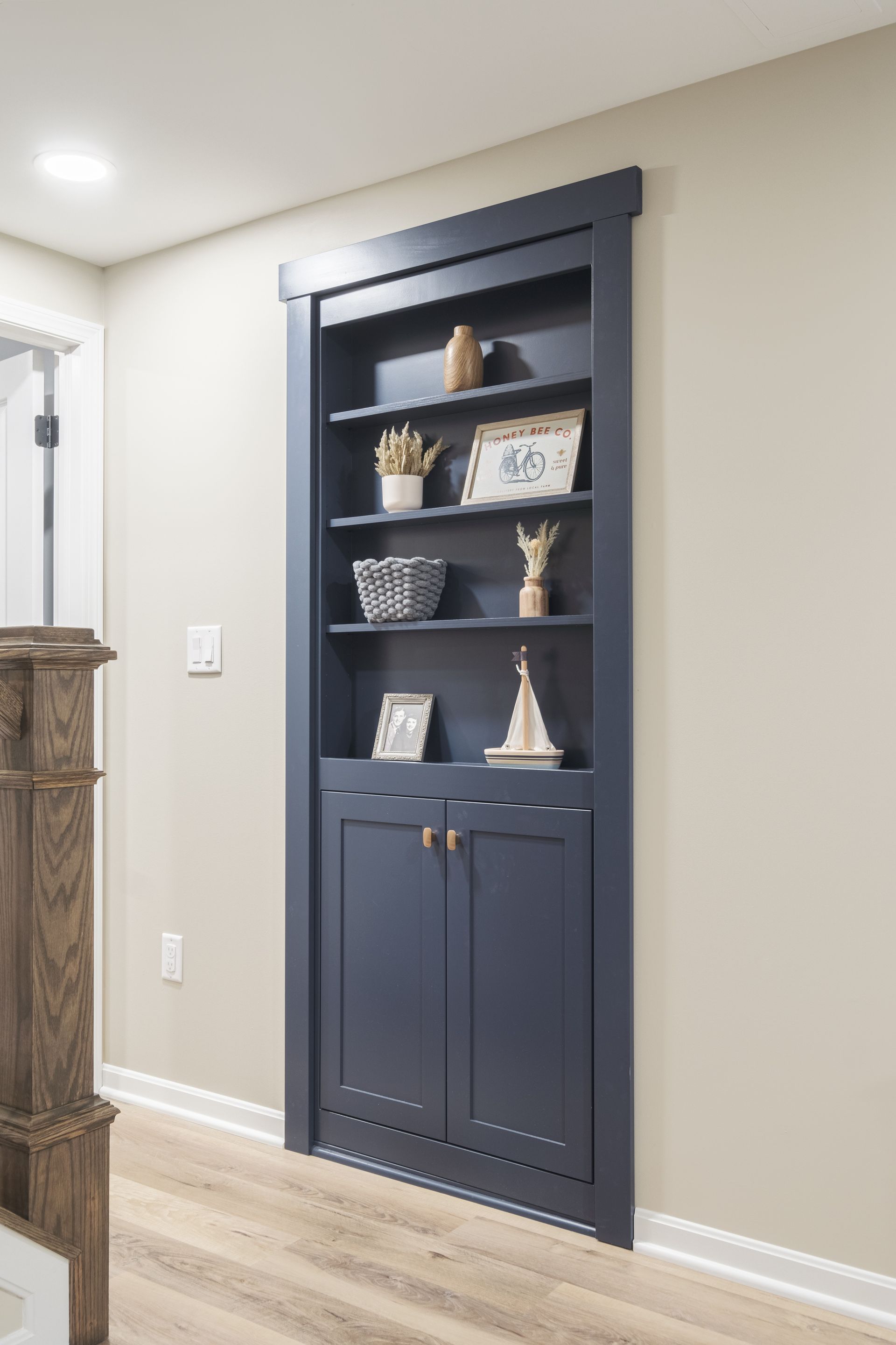 A blue bookshelf is built into a wall in a living room.