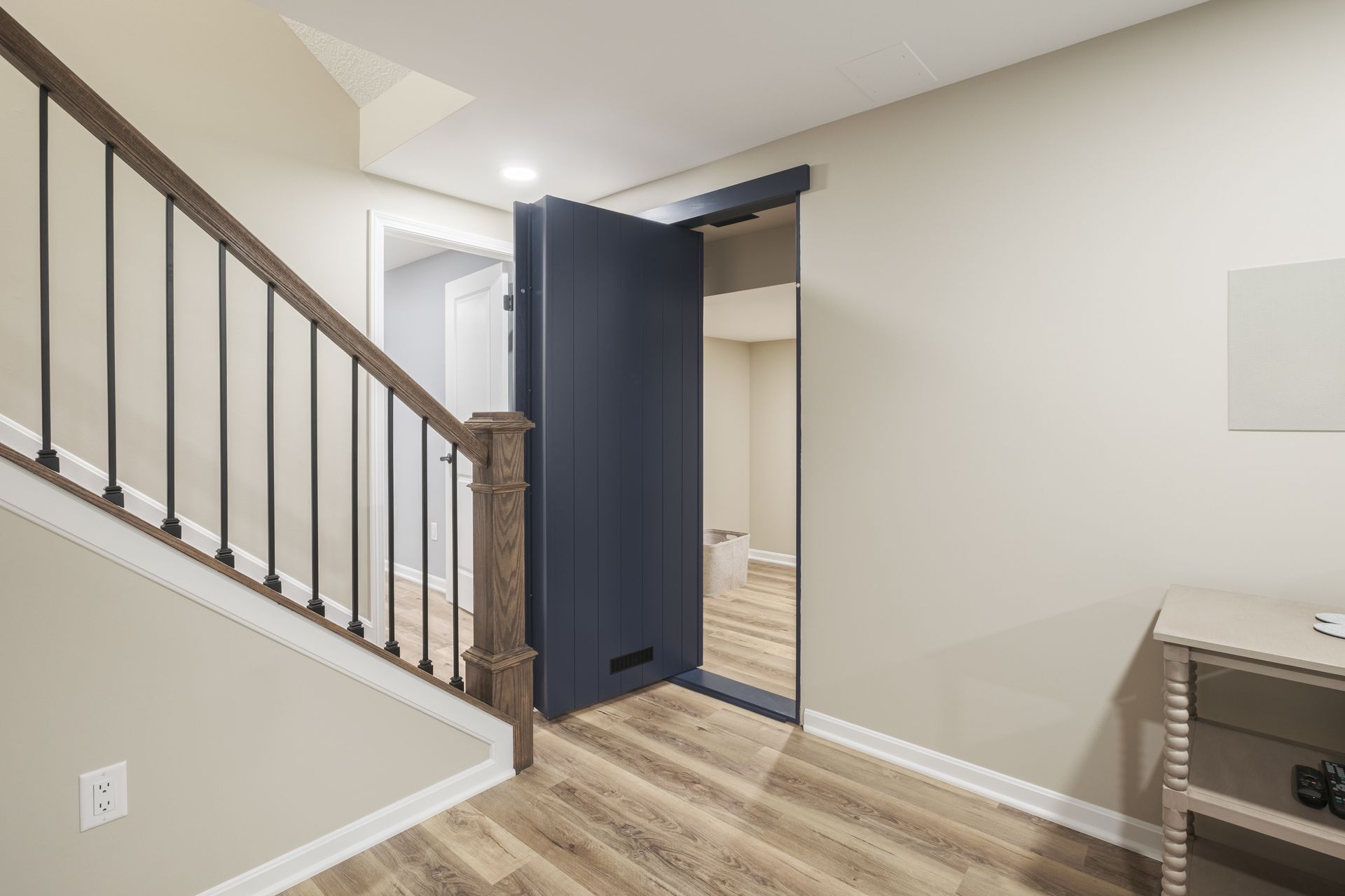 A staircase leading up to a basement with a blue door.
