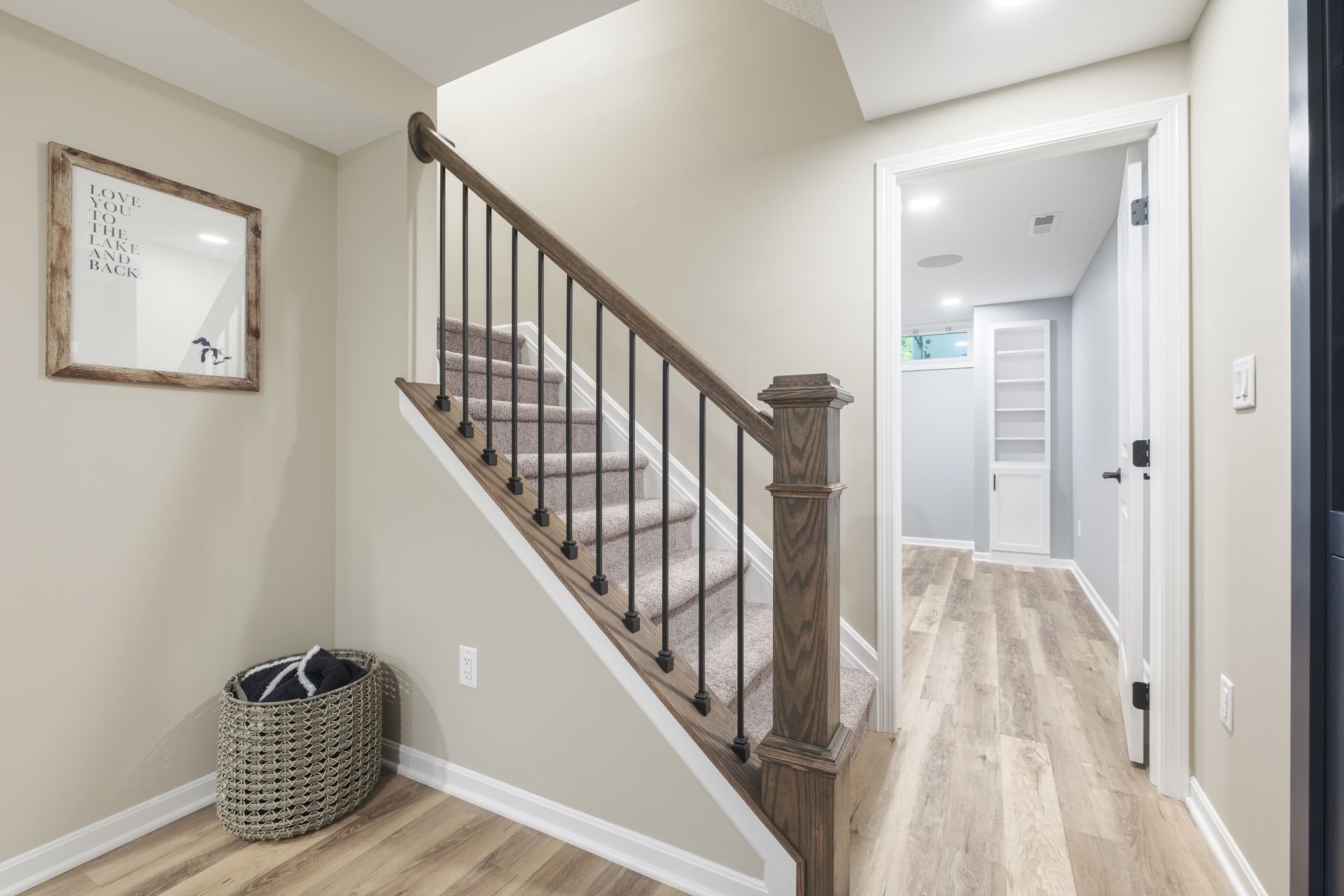 A hallway with stairs leading up to the second floor of a house.