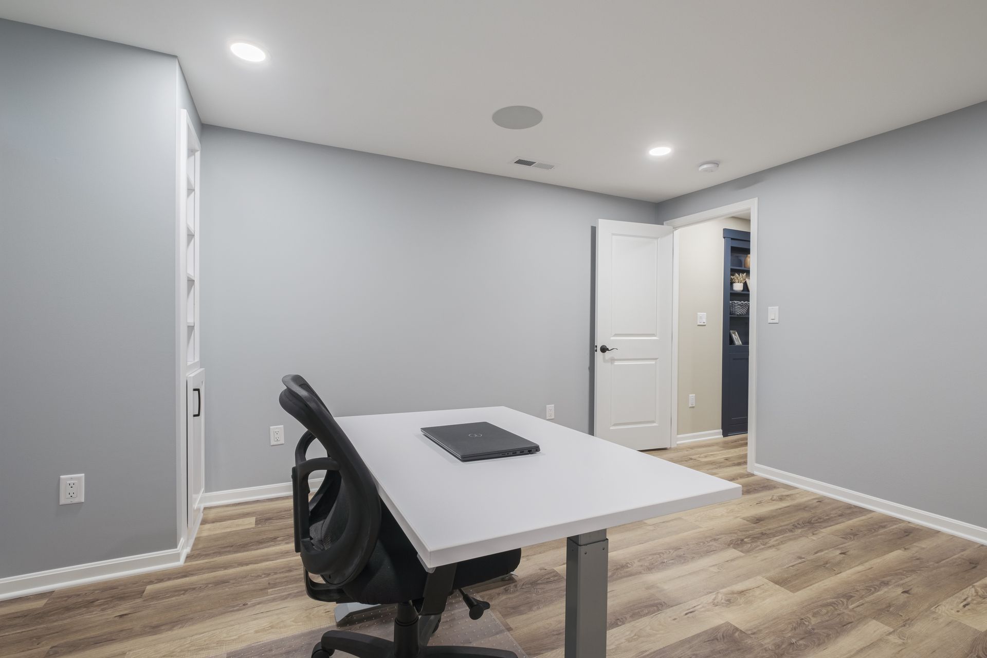 There is a desk and chair in the room.