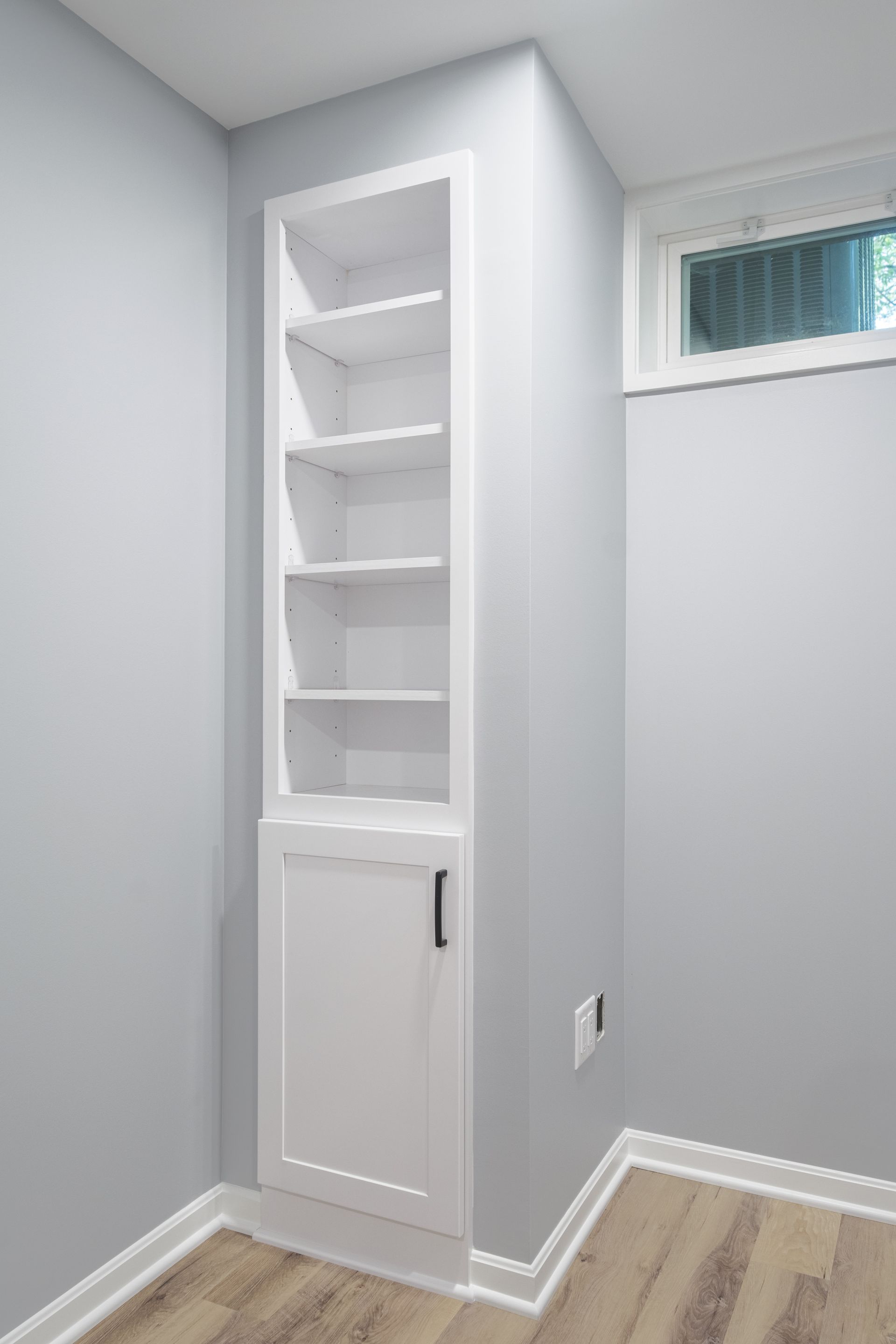 There is a window in the corner of the room.