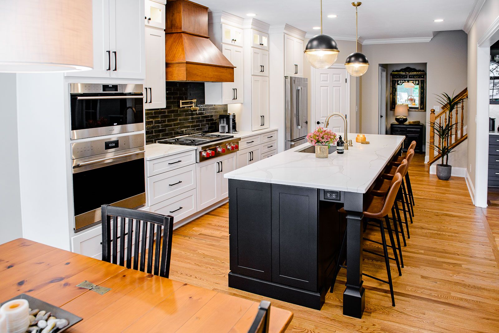 A kitchen with a large island and a dining table.