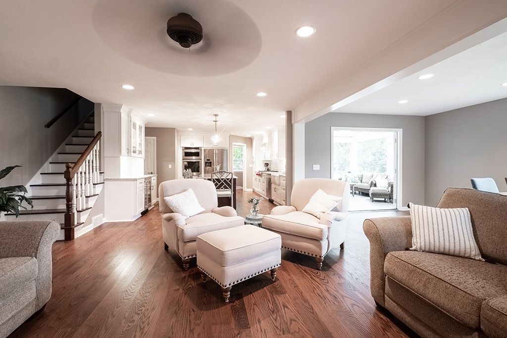 A kitchen with white cabinets , granite counter tops , and stainless steel appliances.