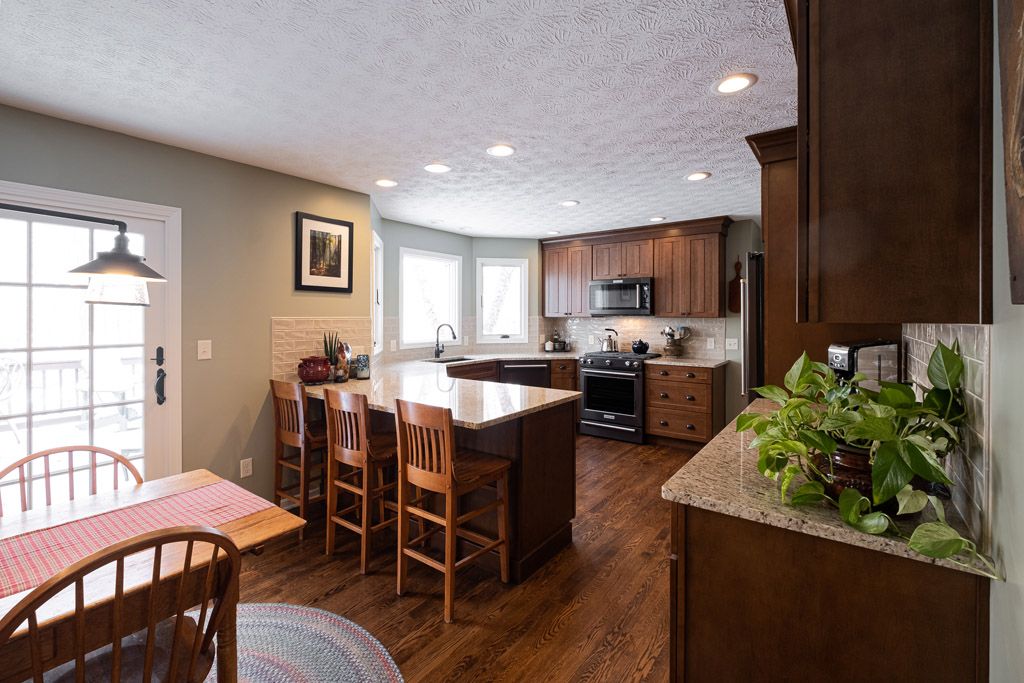 A kitchen with a table and chairs and a large island.