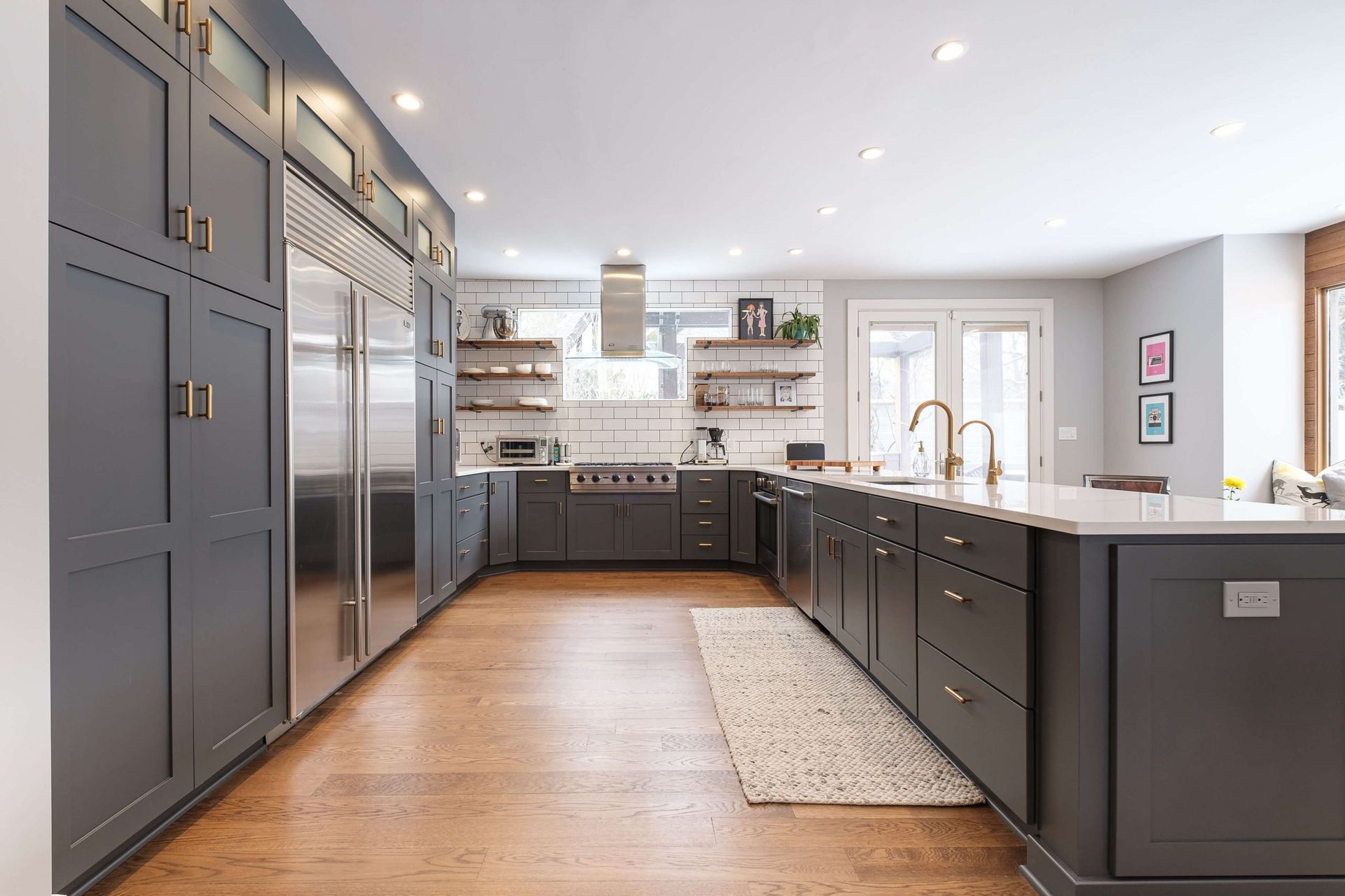A large kitchen with a lot of cabinets and stainless steel appliances.