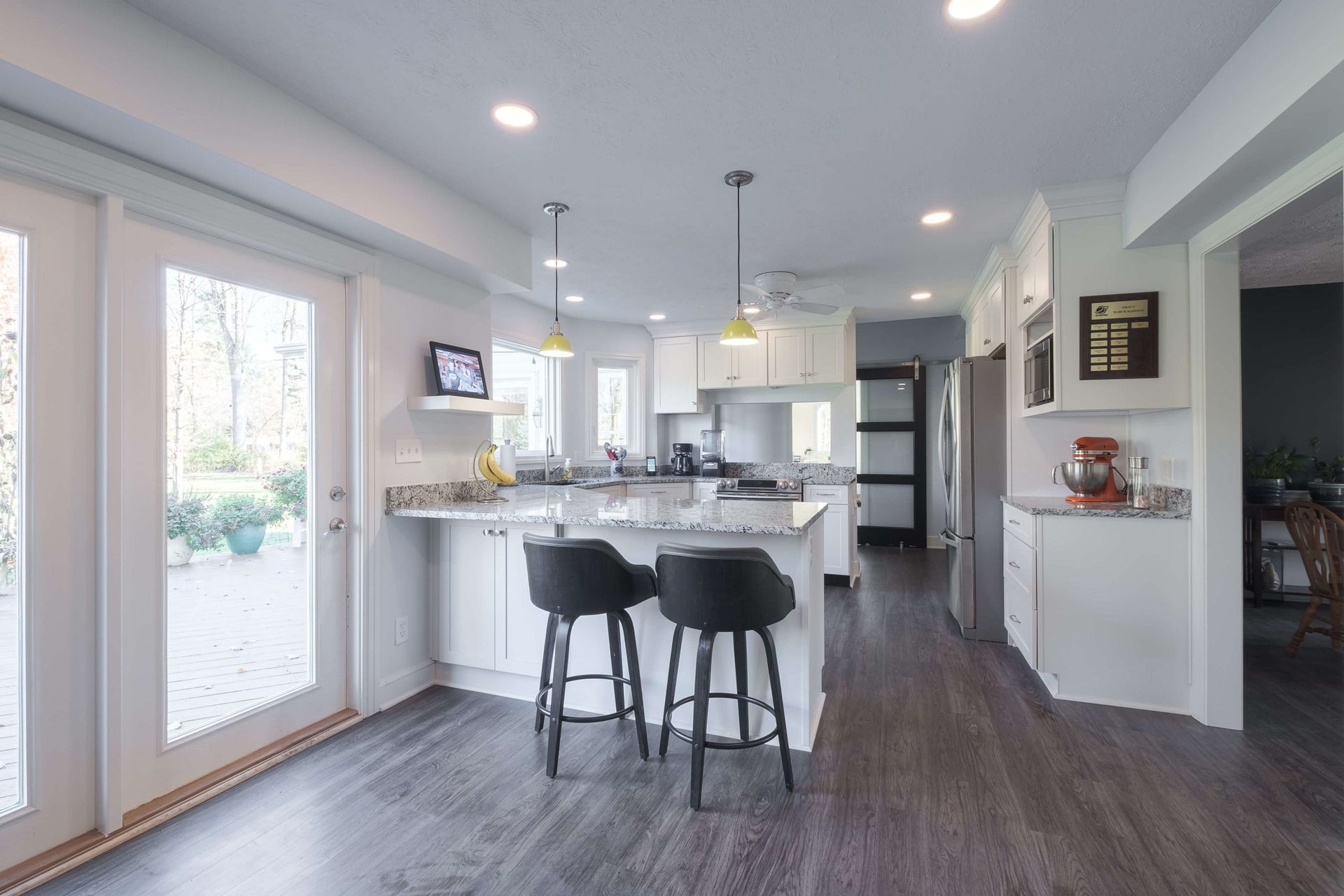 A kitchen with a large island and two bar stools
