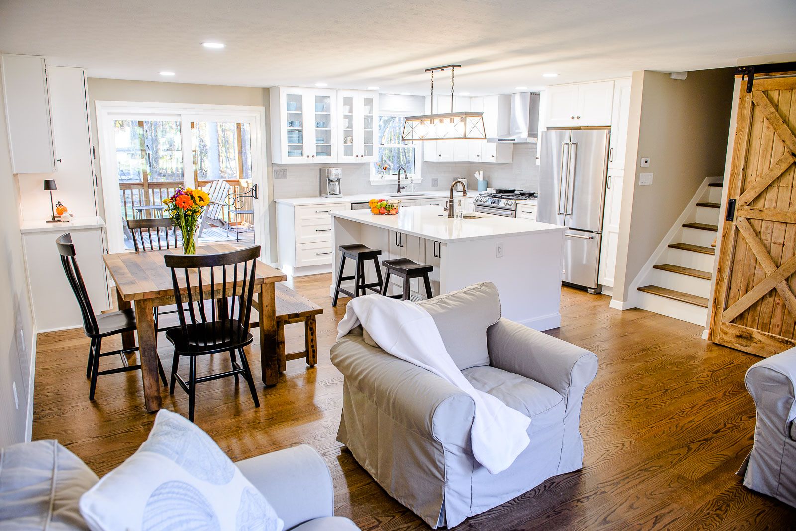A living room with a couch , chair , table and chairs.