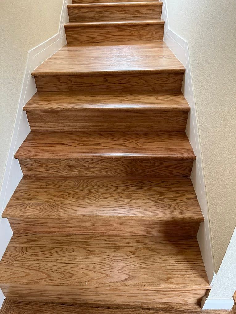 A row of wooden stairs leading up to the second floor of a house.