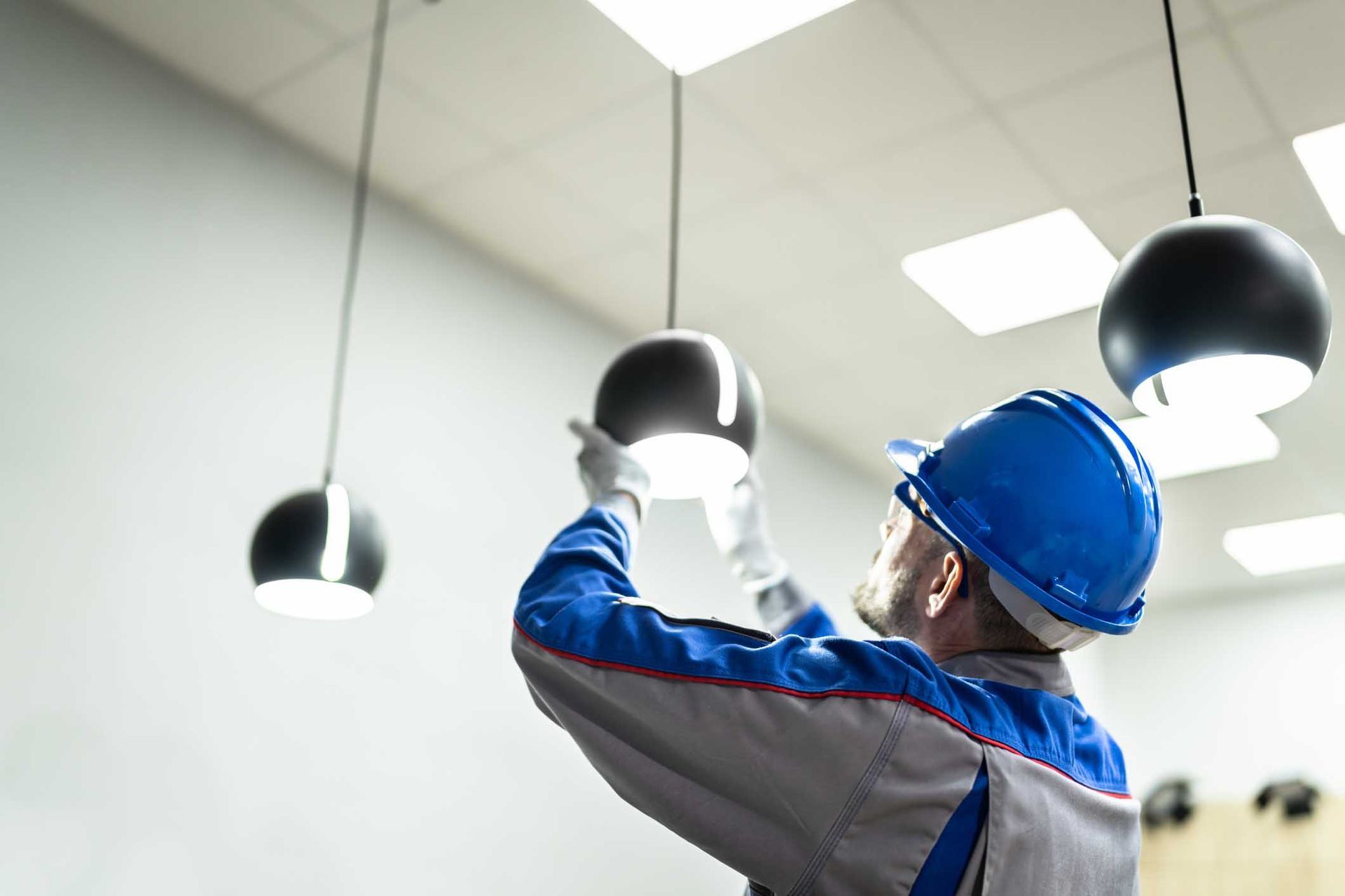 Electrician Installing a Light Fixture — Waconia, MN — Larkin Electric