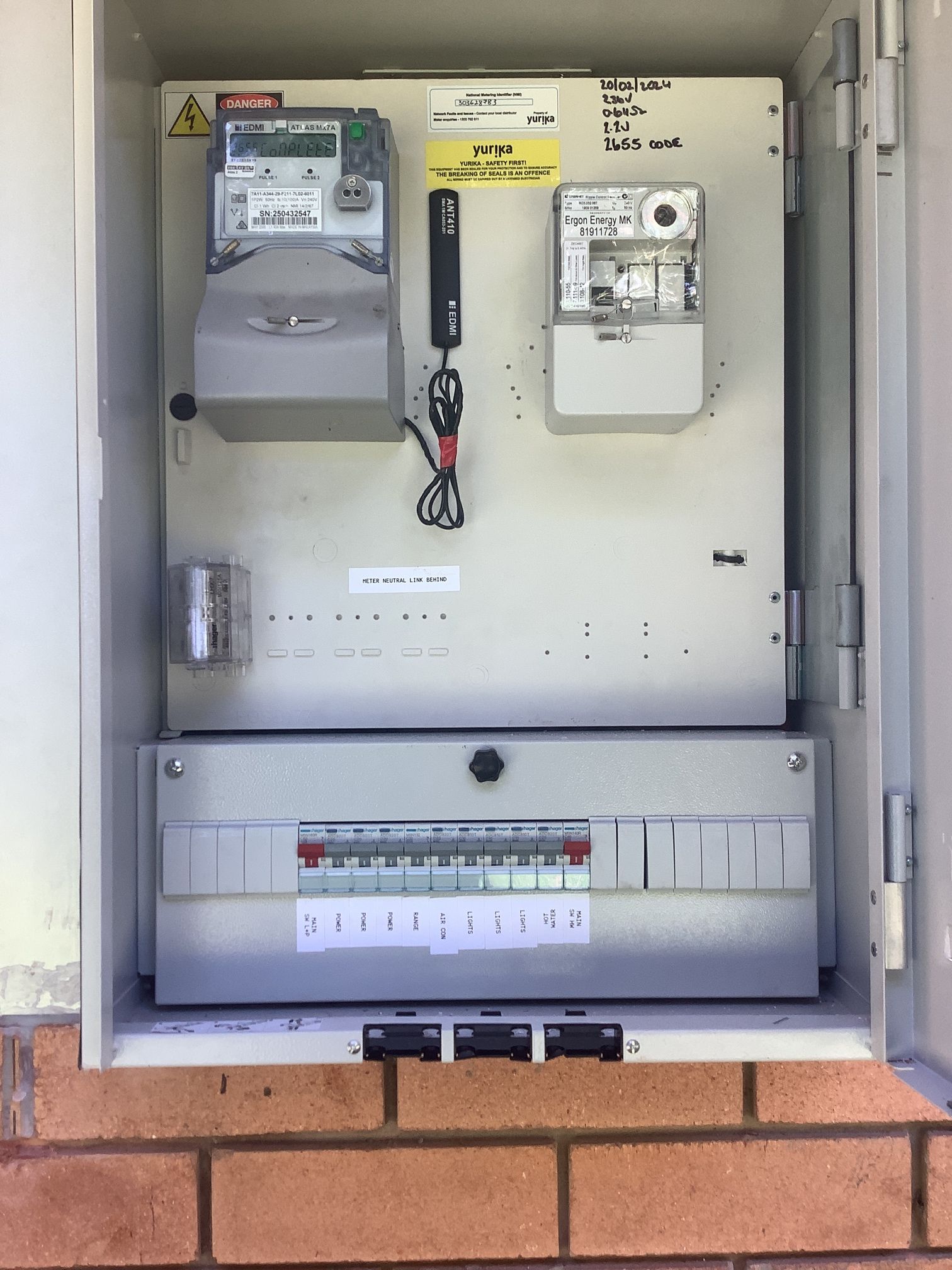 Electrician Using a Multimeter on Wiring in a Floor Outlet, Wearing Red Gloves — LSEA Electrical Group in Bucasia, QLD
