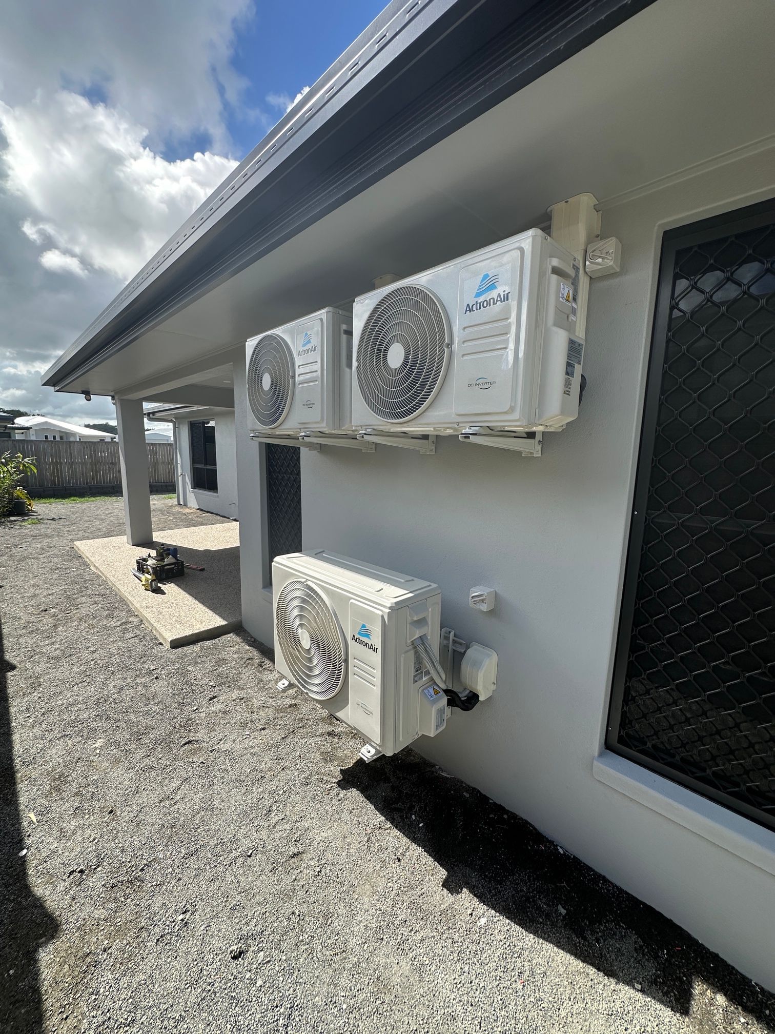 Three Air Conditioning Units Mounted on a White Building Exterior — LSEA Electrical Group in Bucasia, QLD
