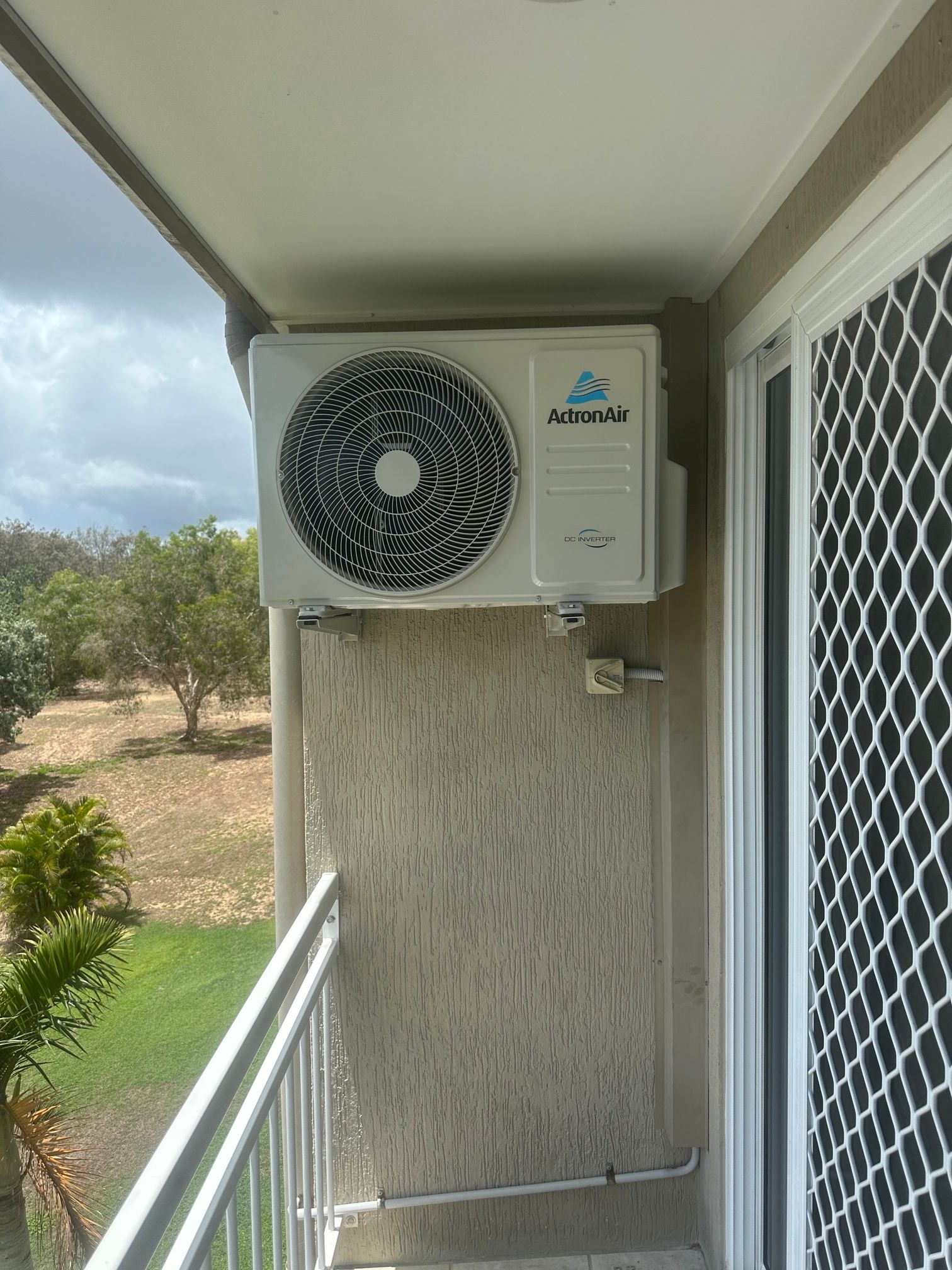 Air Conditioning Unit Mounted on a Balcony Wall — LSEA Electrical Group in Paget, QLD