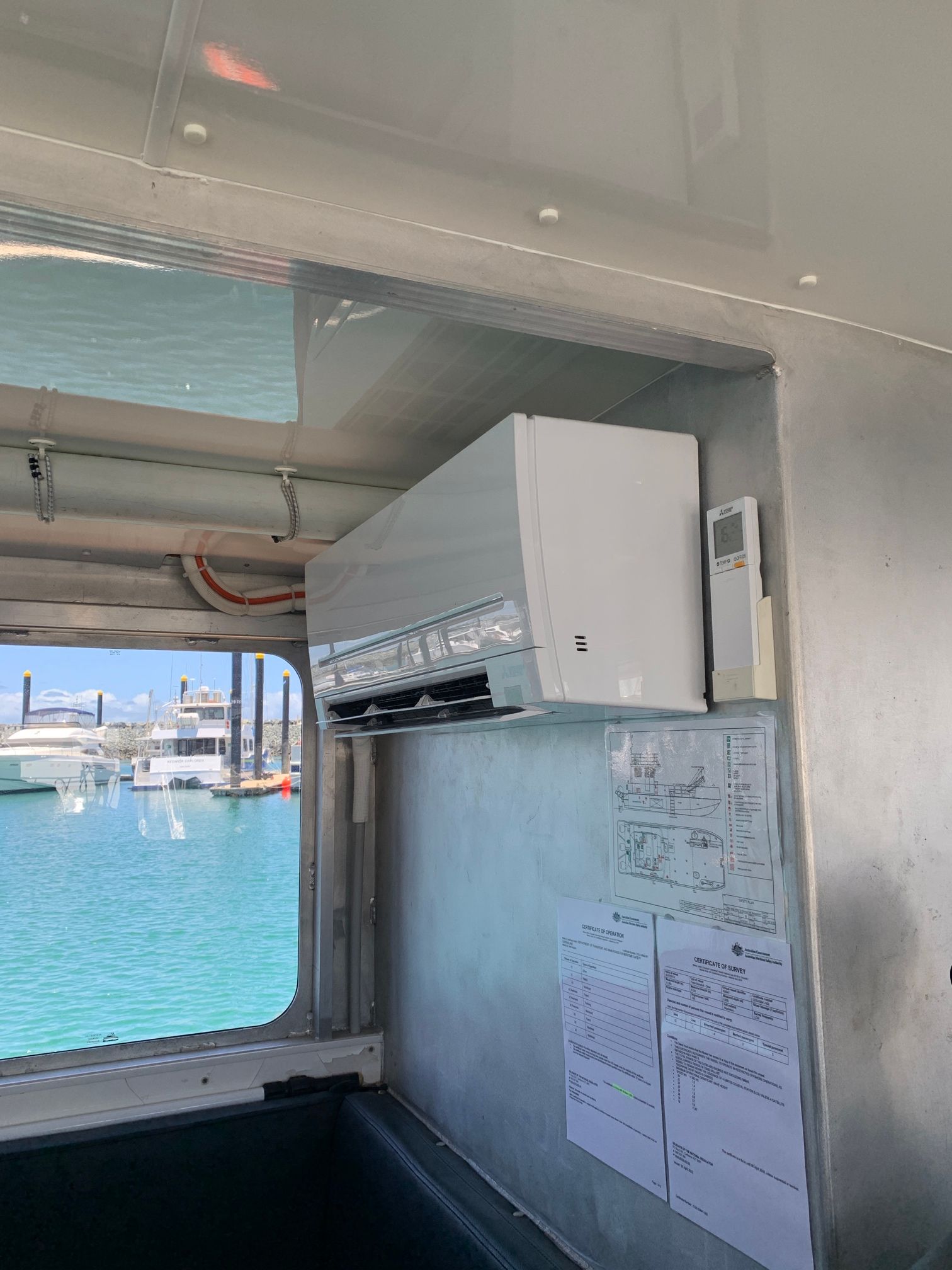 Air Conditioner Mounted on a Wall in a Boat Cabin Overlooking a Marina — LSEA Electrical Group in Paget, QLD