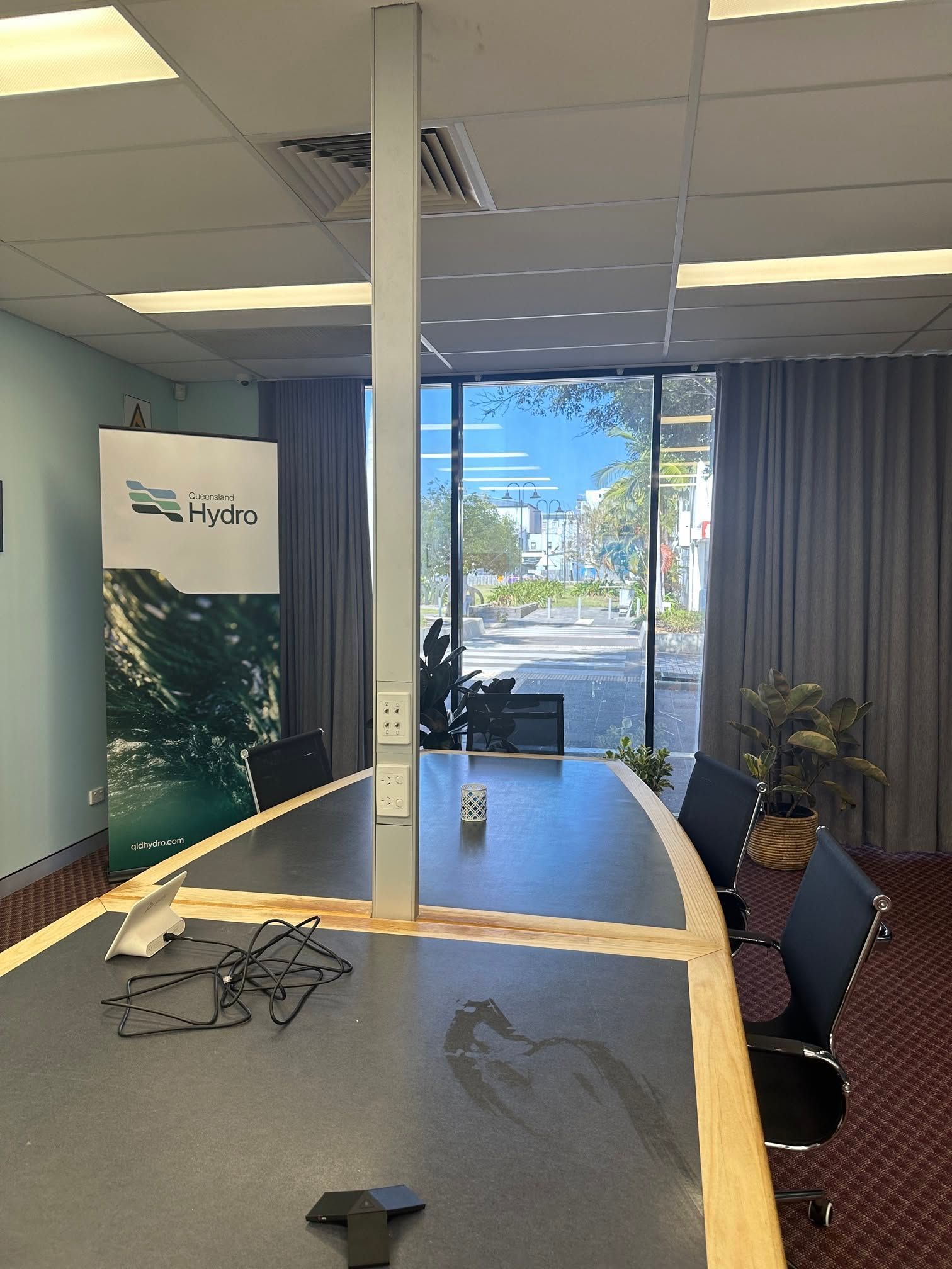 Empty Office Lobby With a Long Table, Chairs, Banner, and Windows — LSEA Electrical Group in Bucasia, QLD