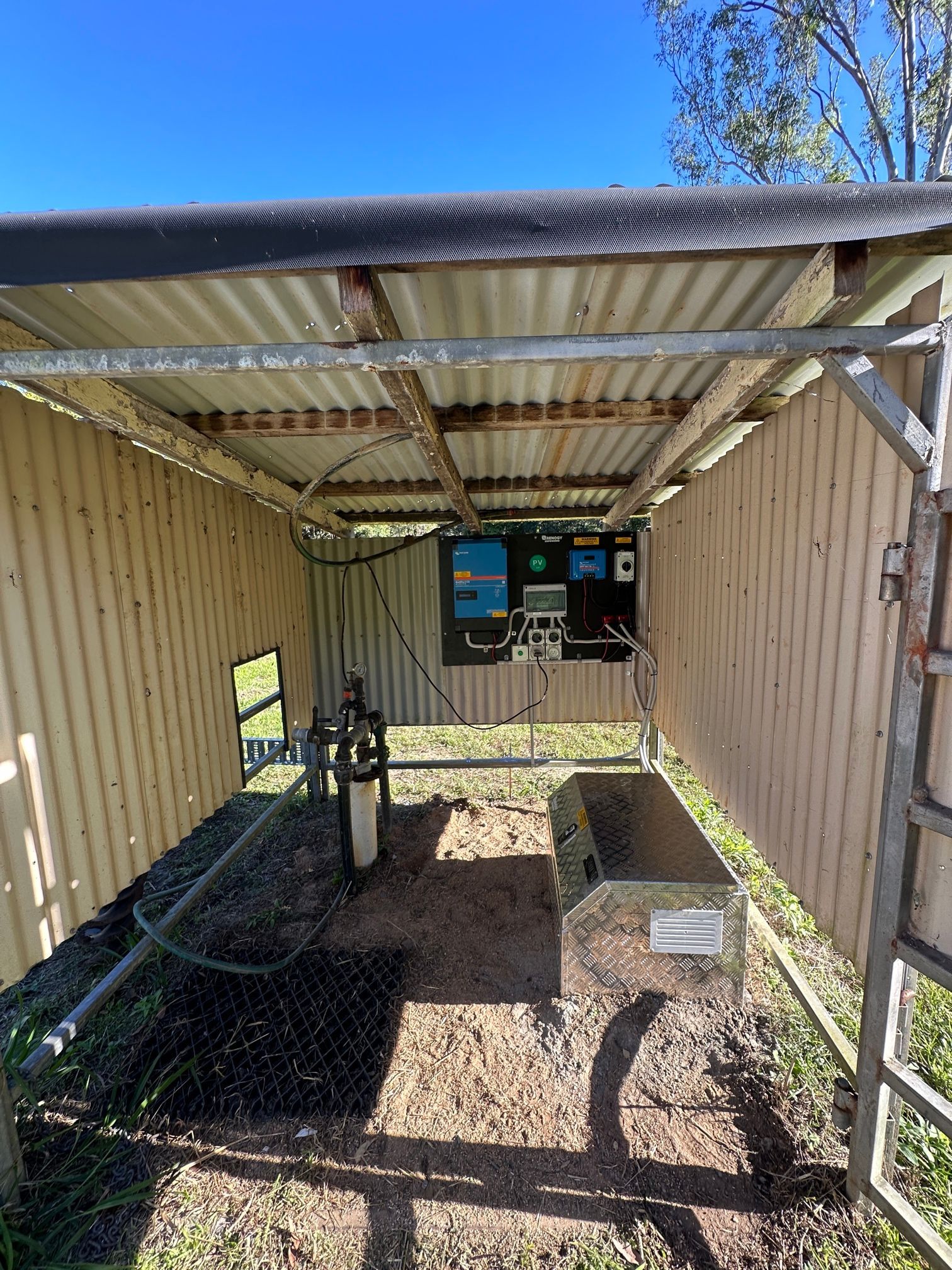 Small Corrugated Metal Shelter With Control Panel And Equipment. Outdoors, Sunny — LSEA Electrical Group in Bucasia, QLD