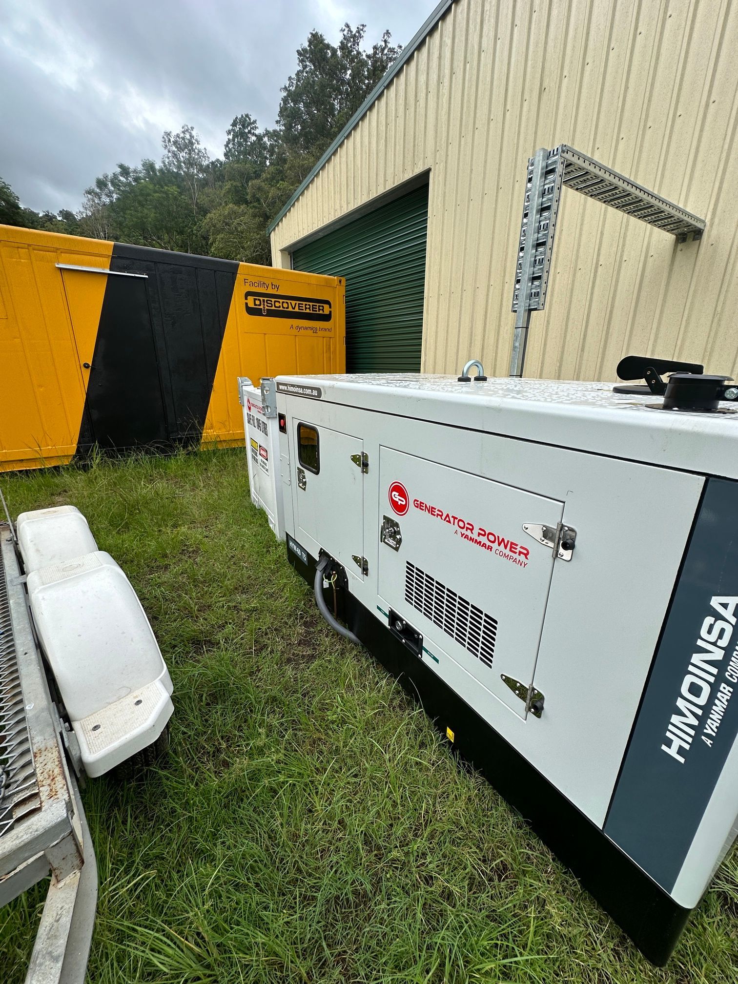 A White and Gray Himoinsa Generator on Grass — LSEA Electrical Group in Paget, QLD