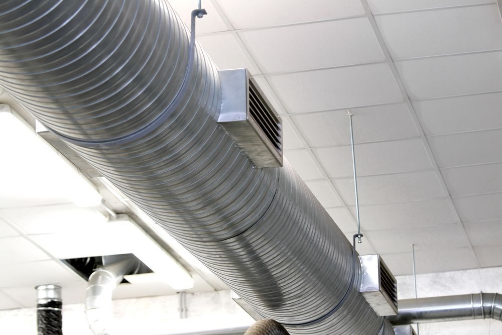 Metal HVAC Ductwork Suspended From a White Ceiling, With Air Vents — LSEA Electrical Group in Bucasia, QLD