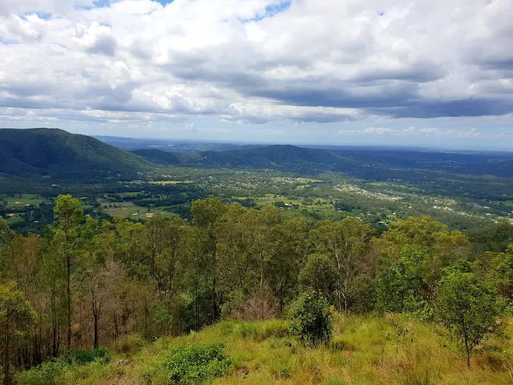 Overlook of a Valley Filled With Trees and Buildings Under a Cloudy Sky — LSEA Electrical Group in Nebo, QLD