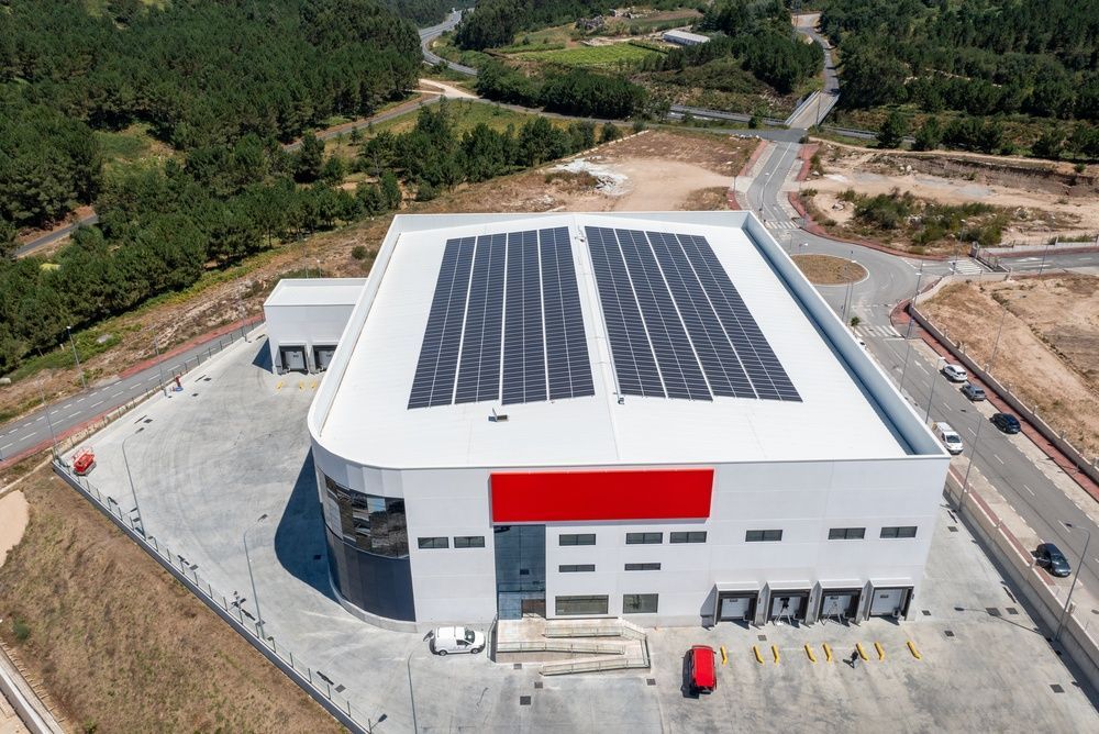 Aerial View of a White Industrial Building With Solar Panels — LSEA Electrical Group in Paget, QLD